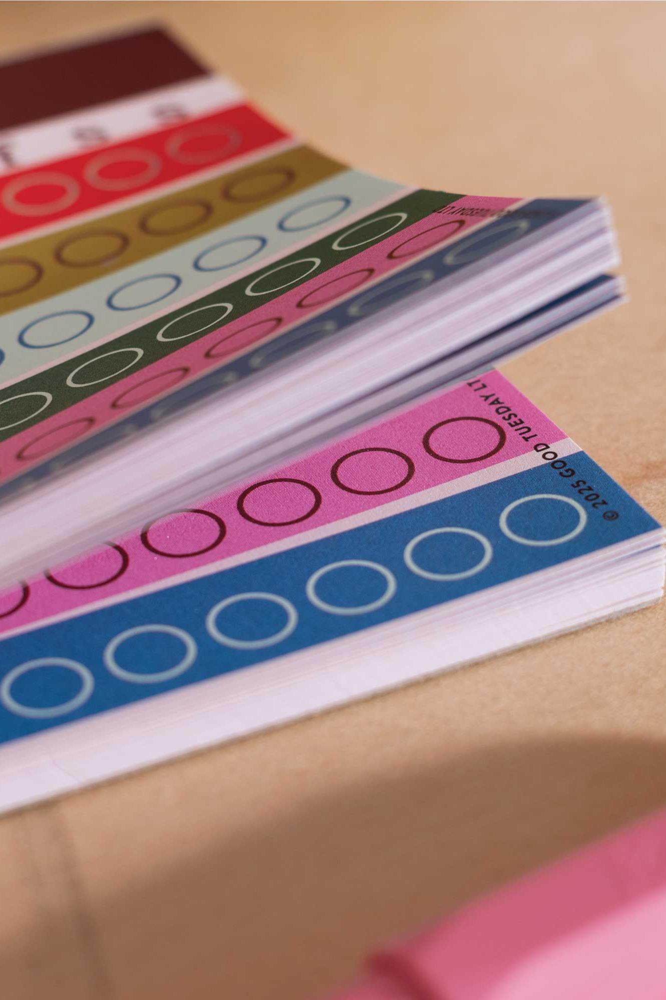 Colourful circular labels on a habit tracker journal