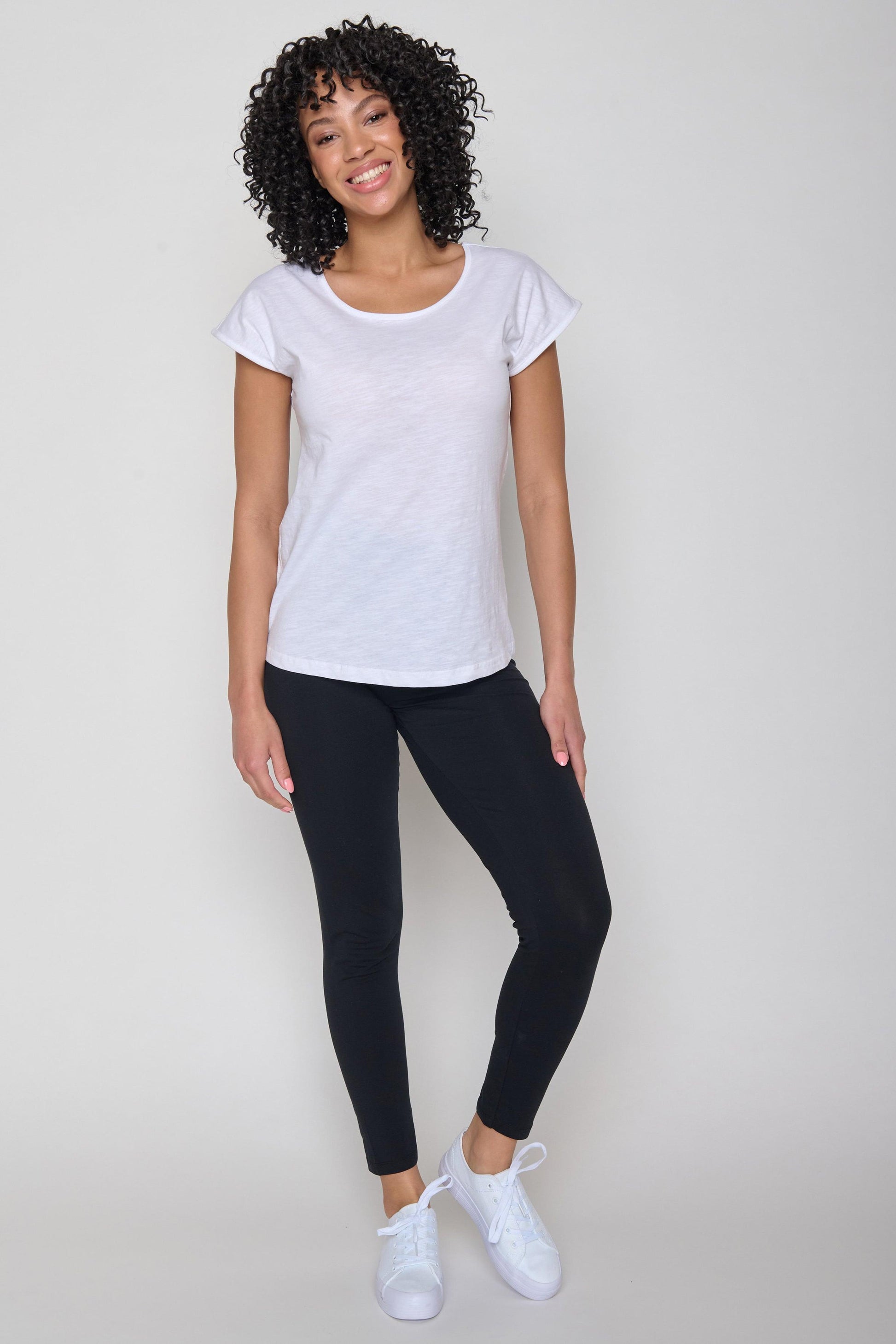 The organic cotton white t-shirt styled with black trousers and white trainers.