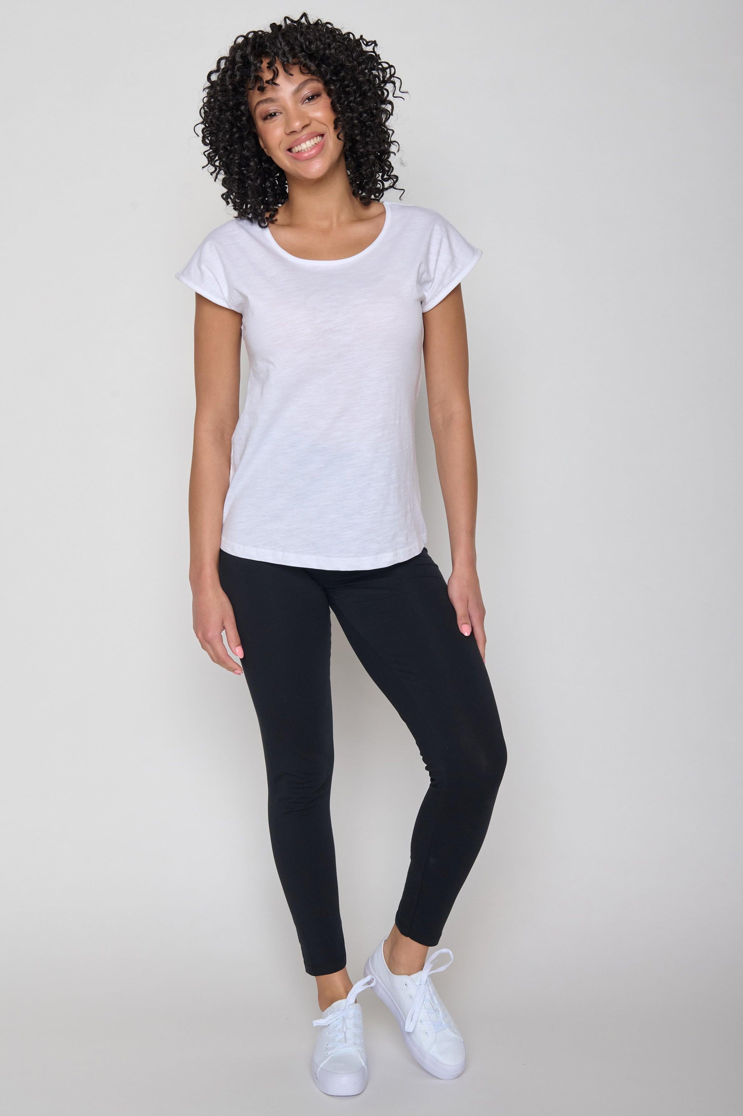 The organic cotton white t-shirt styled with black trousers and white trainers.