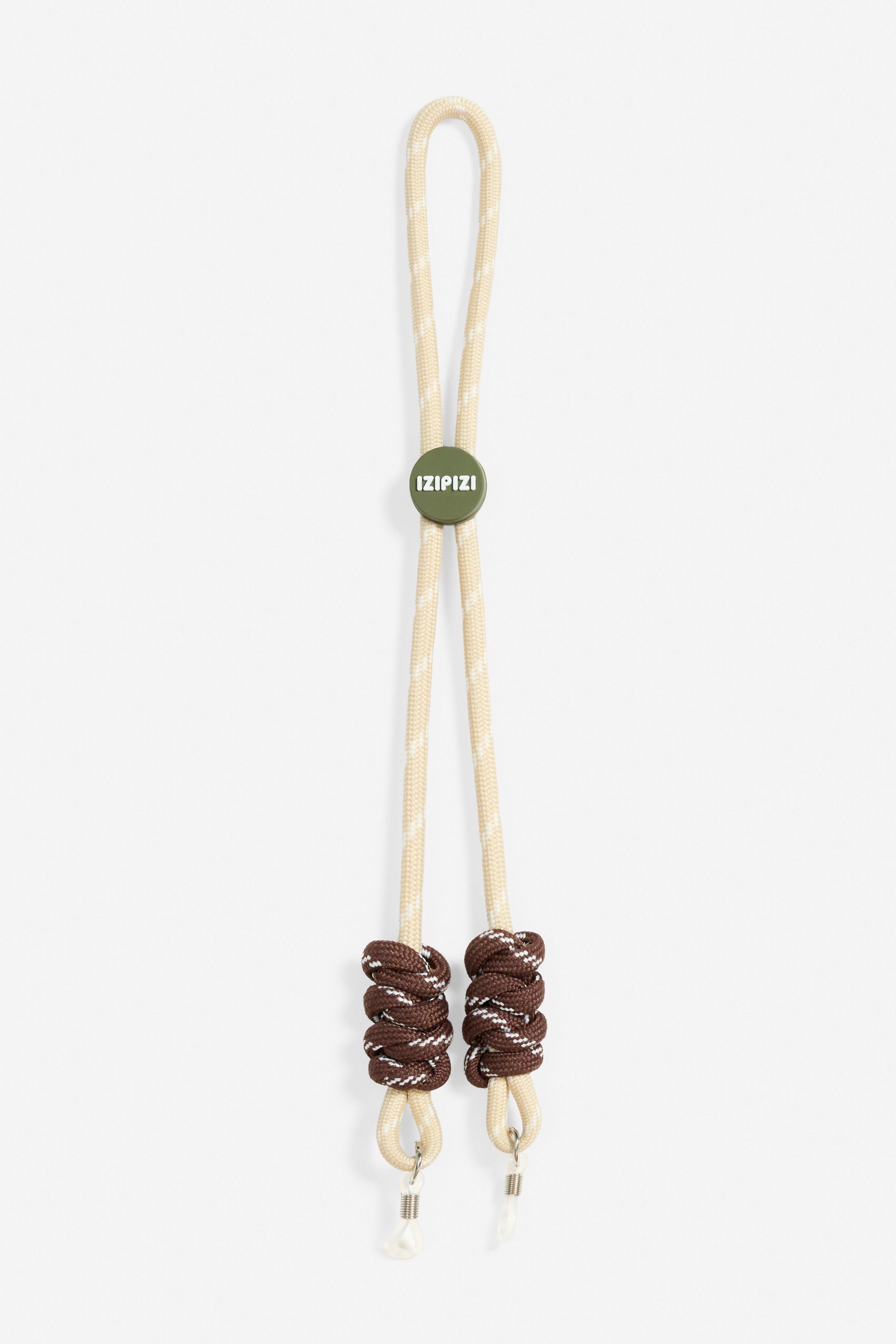 Beige glasses cord with brown beads and a green tag on a white background