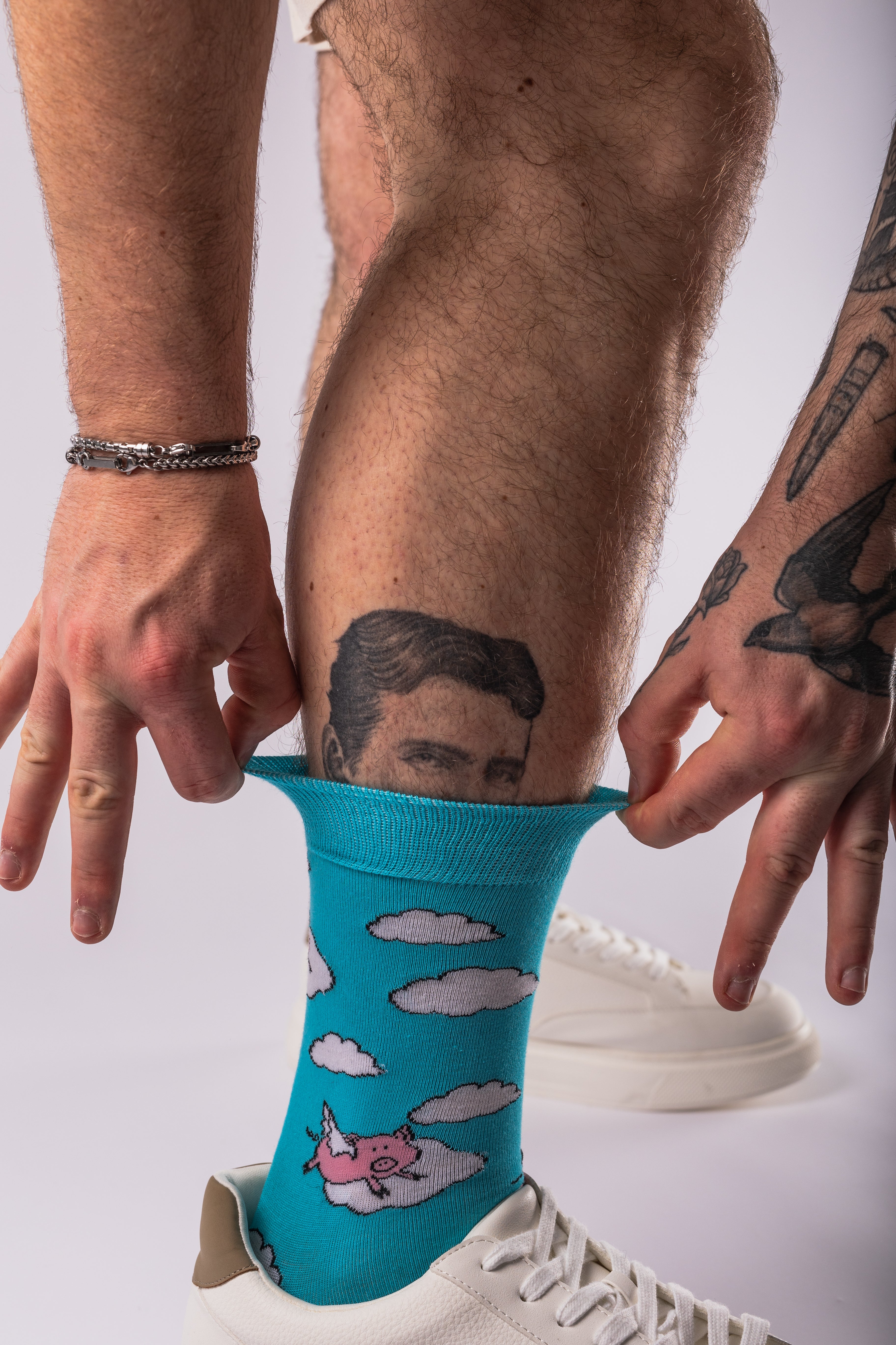 Man wearing blue socks with pigs flying design