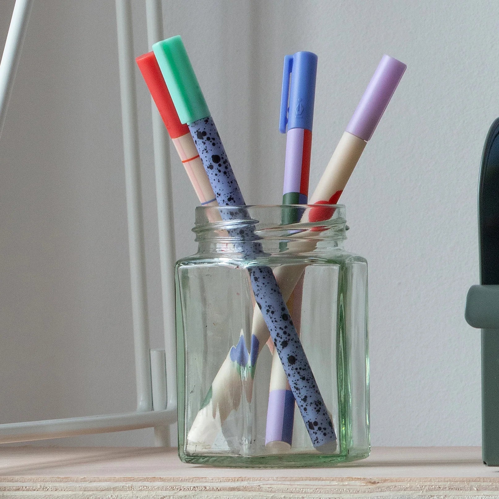 The pens displayed in a glass jar, highlighting the colours and slim design.