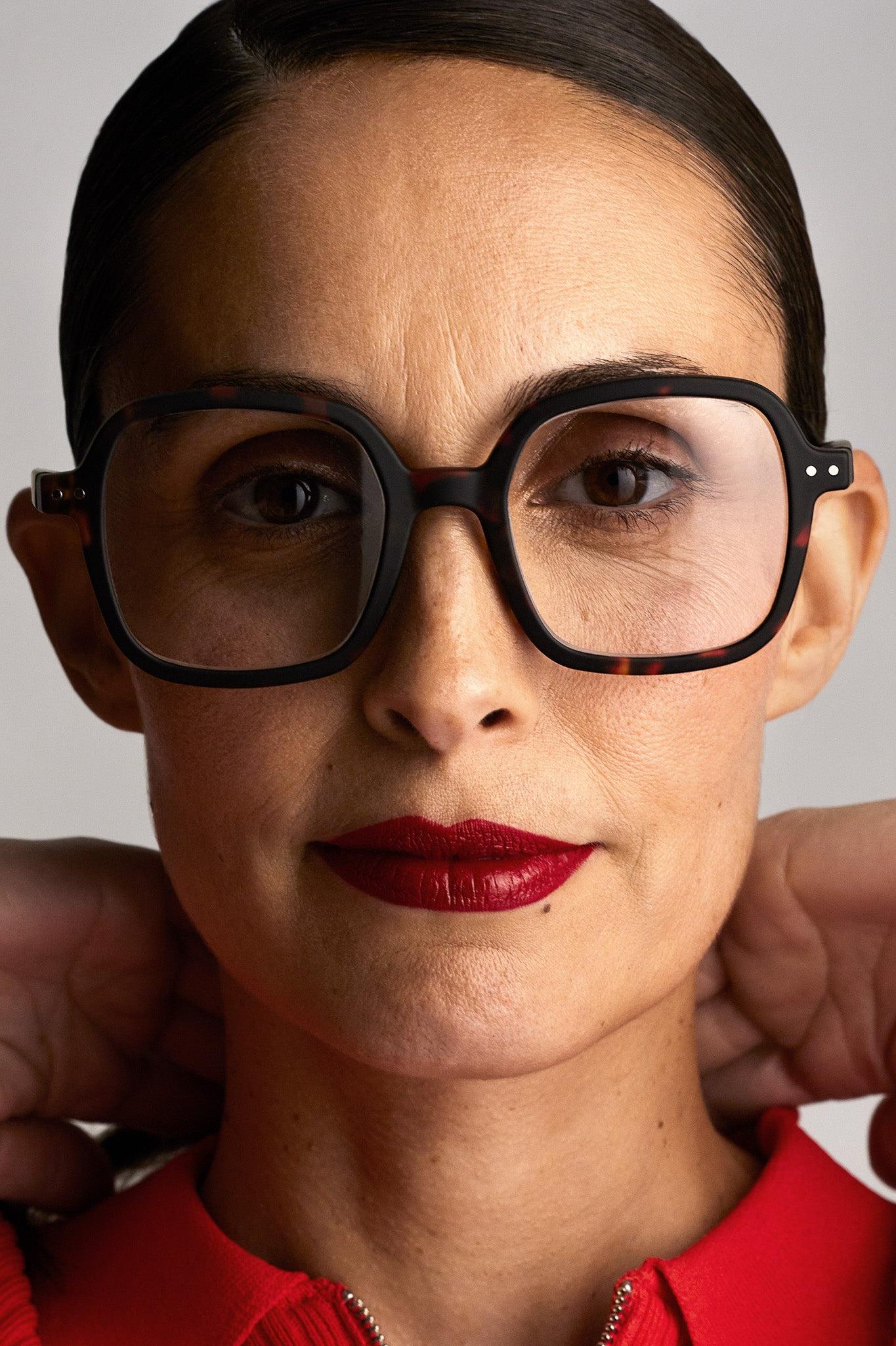 Lifestyle shot of a person wearing the Izipizi Reading #OFFICE Tortoise glasses, demonstrating their oversized design.