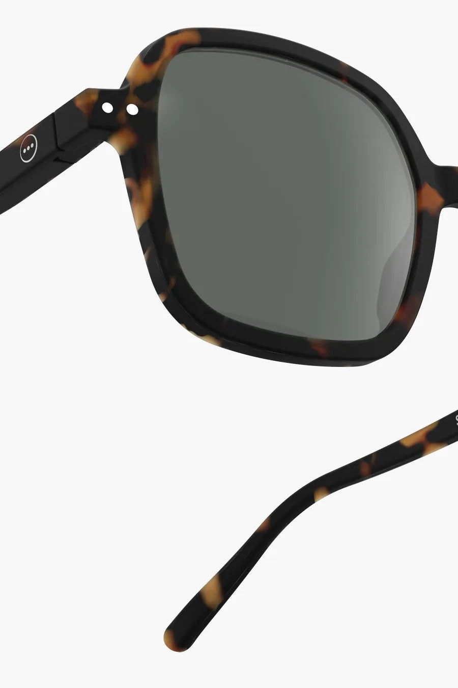 Side view of Izipizi sunglasses, showcasing their oversized square design with a tortoiseshell pattern.
