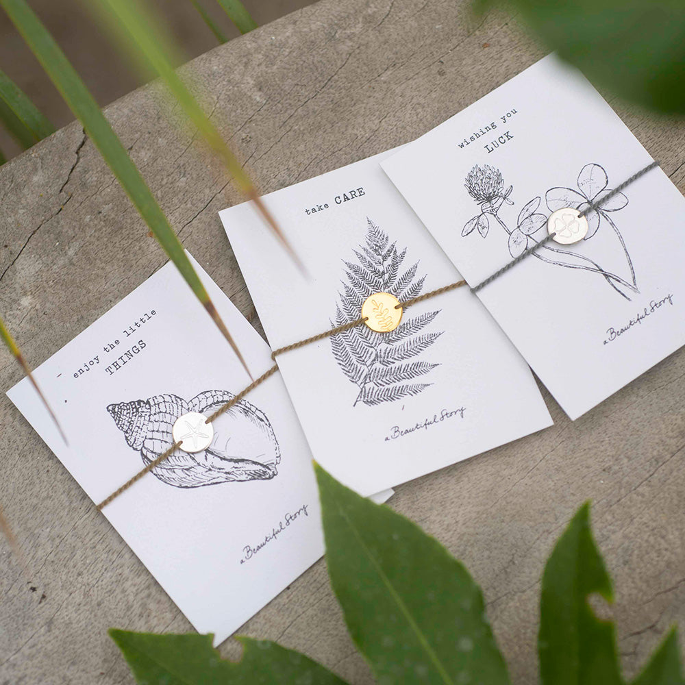 Set of three cards with nature-themed illustrations on a textured surface.