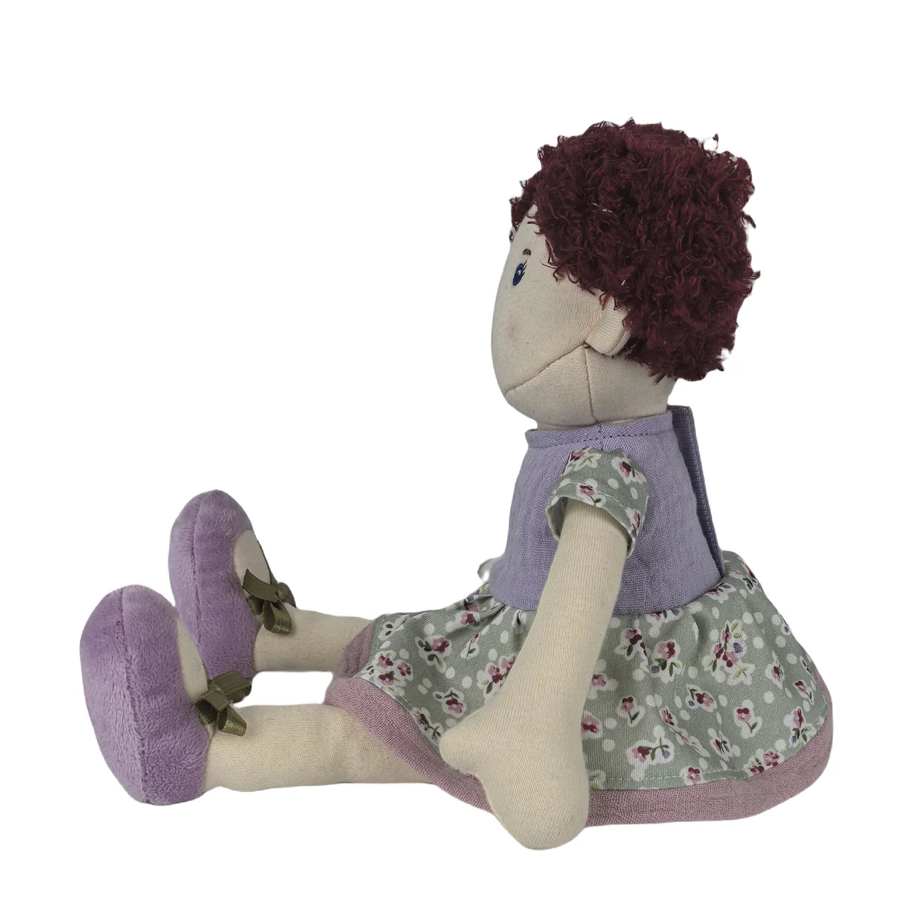 Stuffed doll with purple dress and floral skirt on a white background
