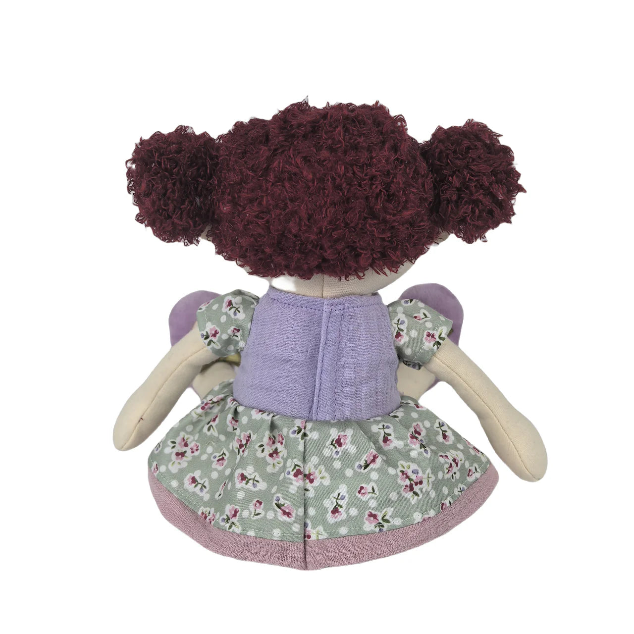 Toy doll with floral dress and purple top on a white background