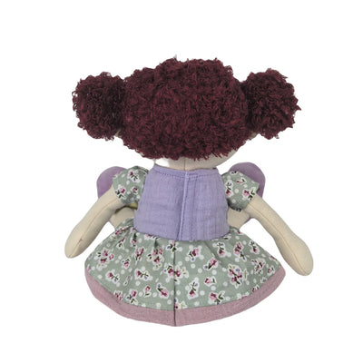 Toy doll with floral dress and purple top on a white background
