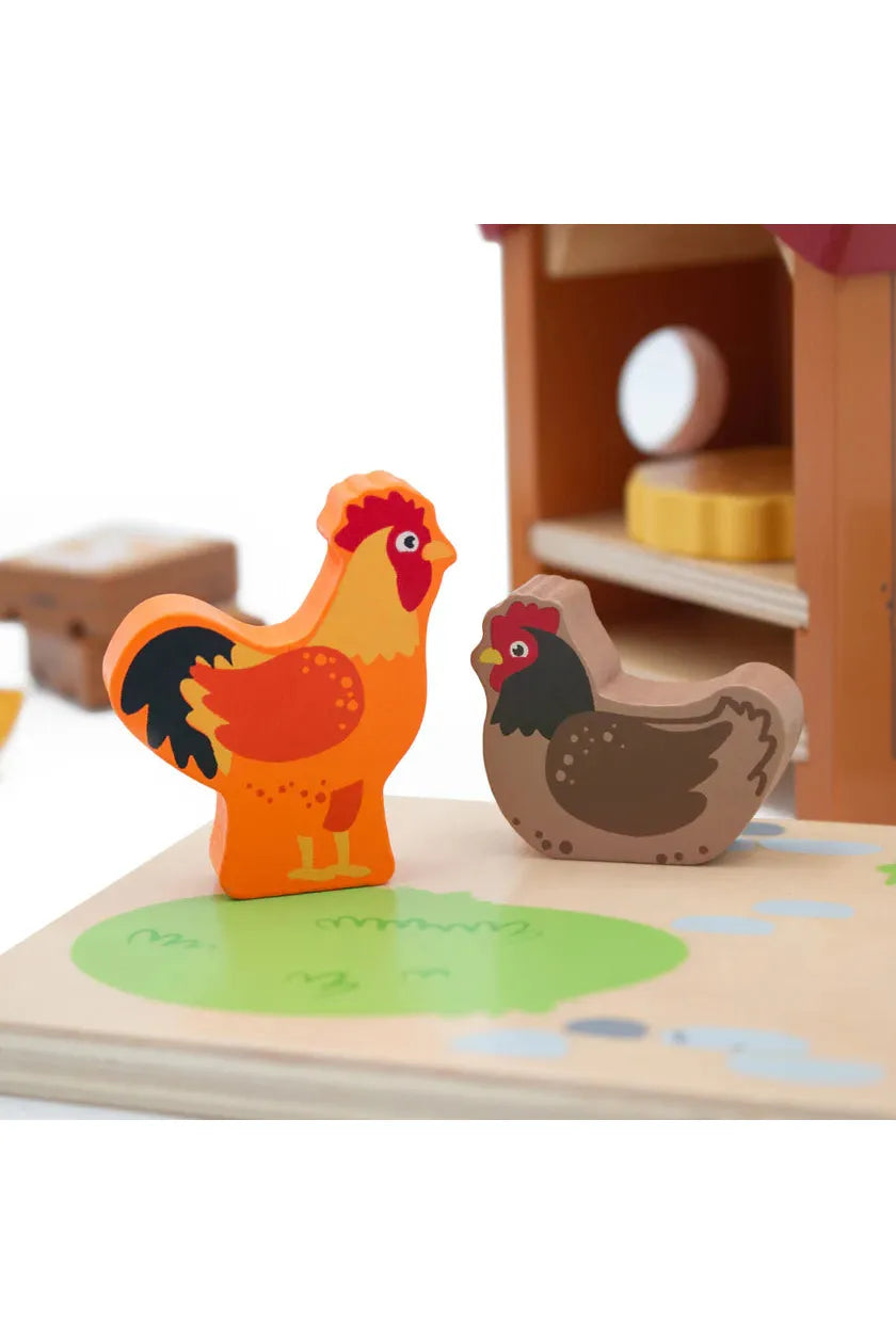 Wooden farm animal toys, including a rooster and a hen, on a wooden board with a barn background.