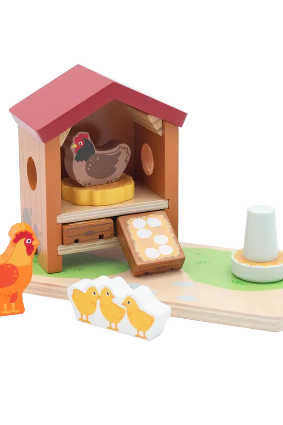 Wooden toy chicken coop with chickens and chicks on a white background
