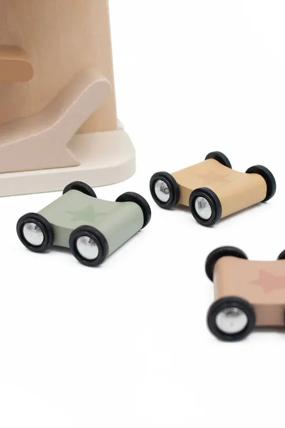 Three toy cars with wheels attached on a white background.