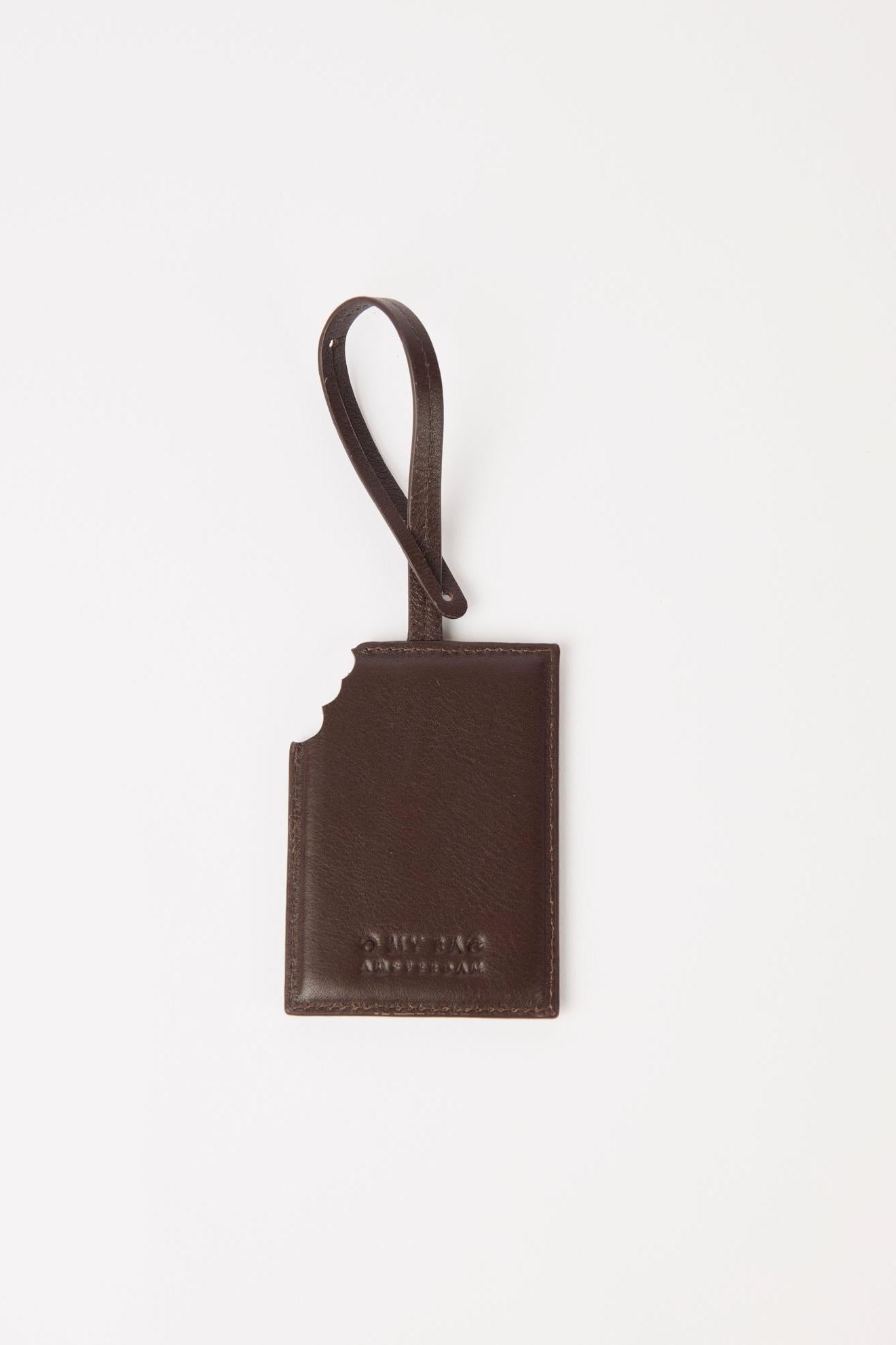 Brown leather luggage tag on a white background