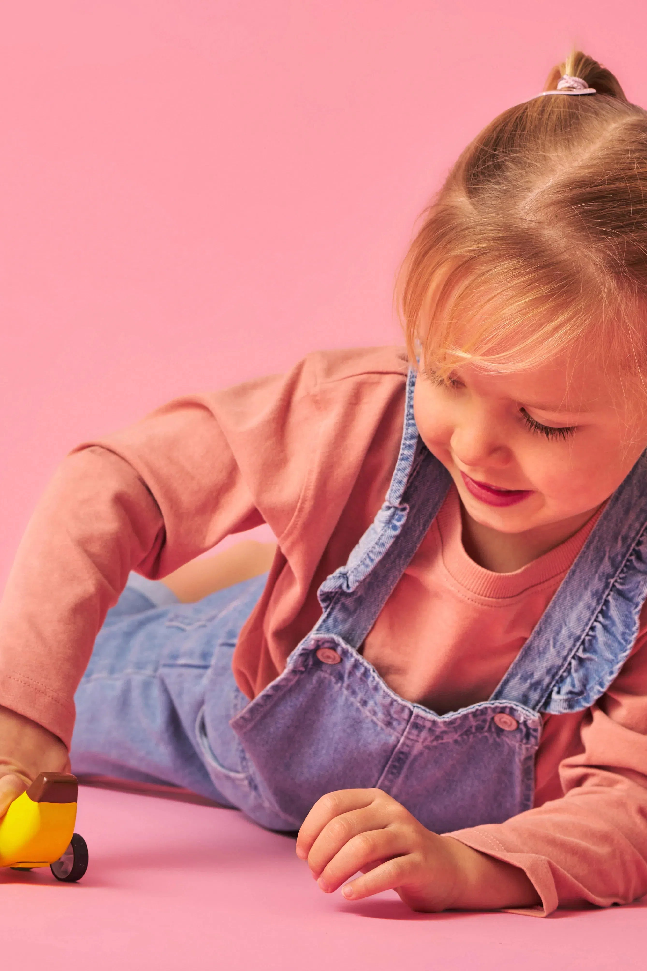 Child playing with banana pullback car.