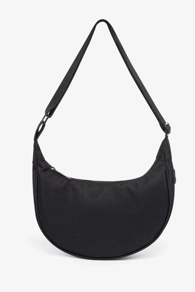 A black half-moon-shaped crossbody bag with an adjustable strap and zippered closure.