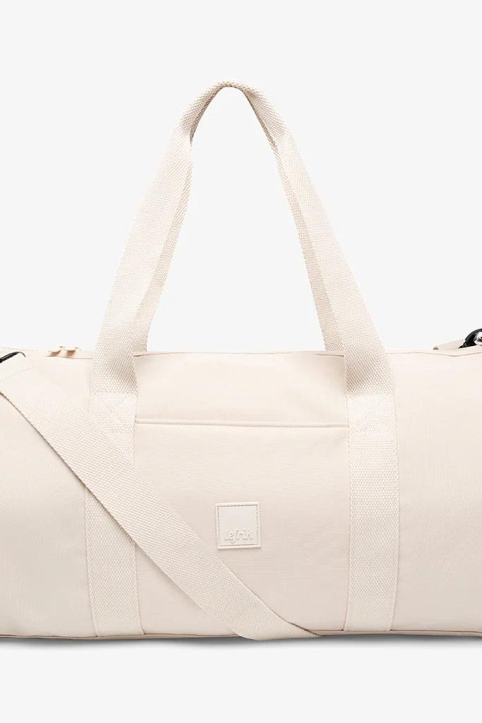 Front view of the Lefrik Getaway Bag in Ecru, a spacious duffle bag, showcasing a detachable shoulder strap.