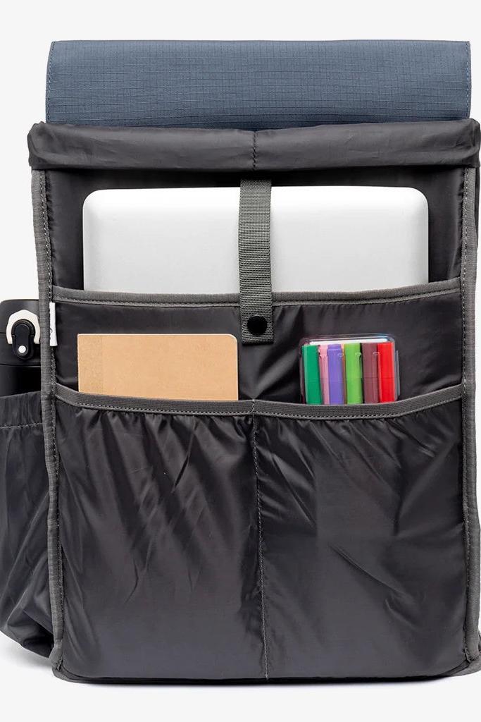 Interior view of the Lefrik Backpack, revealing a spacious main compartment with a padded laptop pocket suitable for up to 13.6-inch laptops, two organisers for smaller items, and an interior bottle pocket.