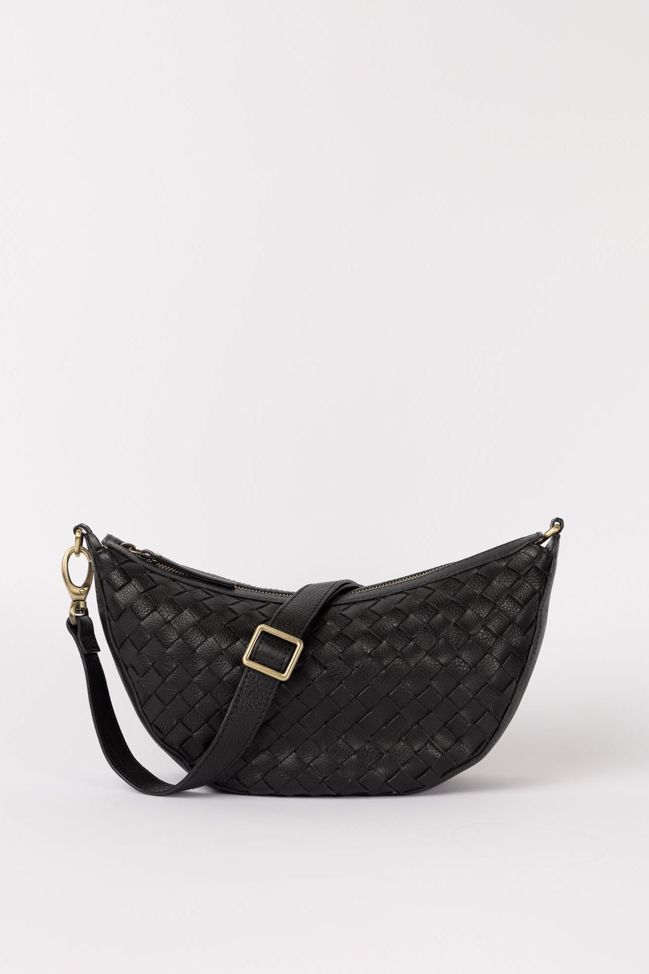 Black woven handbag with a gold buckle on a white background