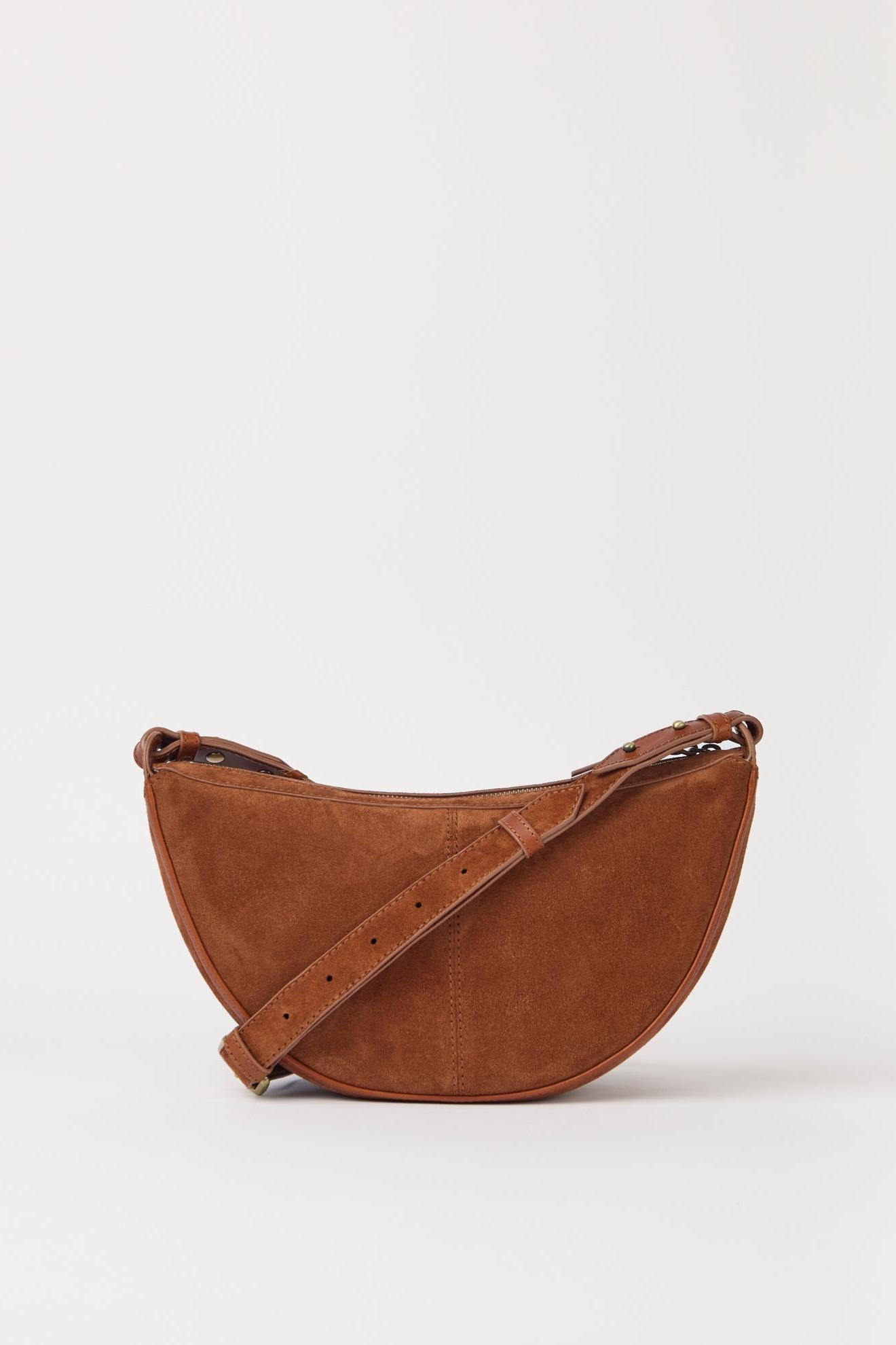 Brown leather saddle bag on a light gray background