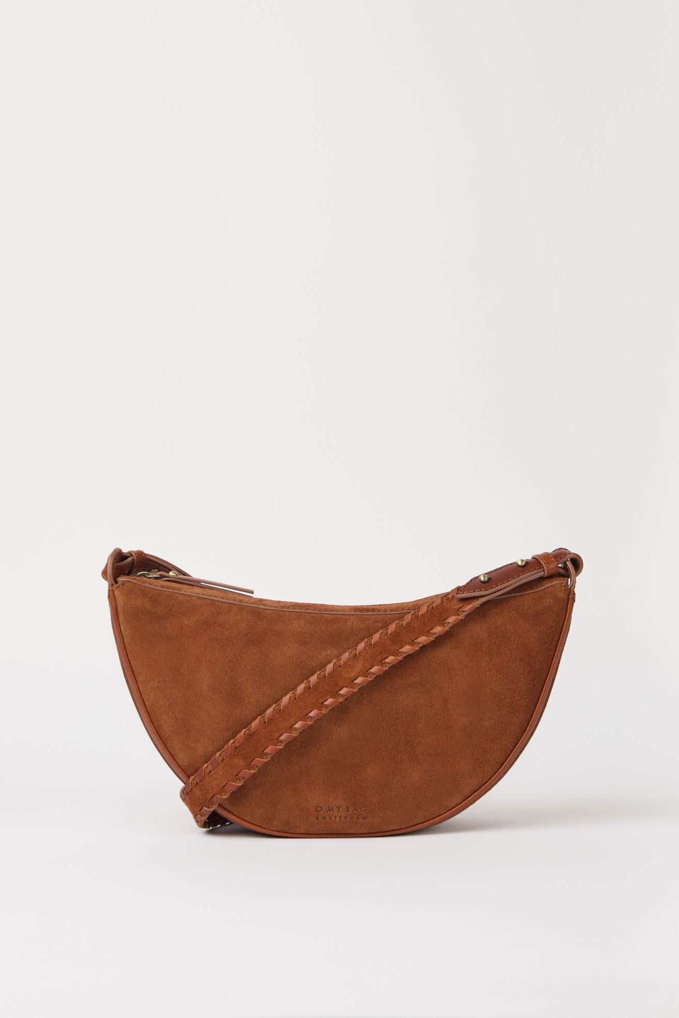 Brown suede handbag with a strap on a white background
