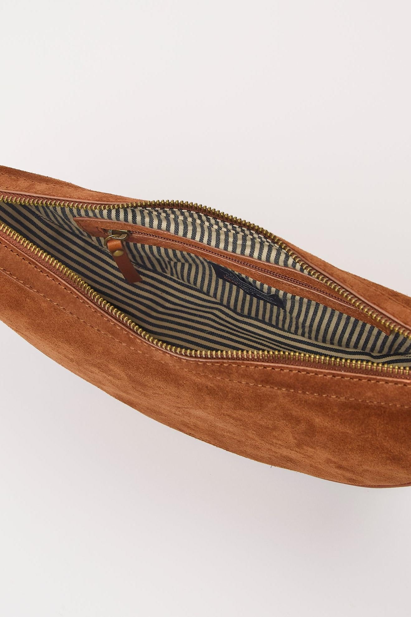 Brown suede waist bag with striped lining on a white background