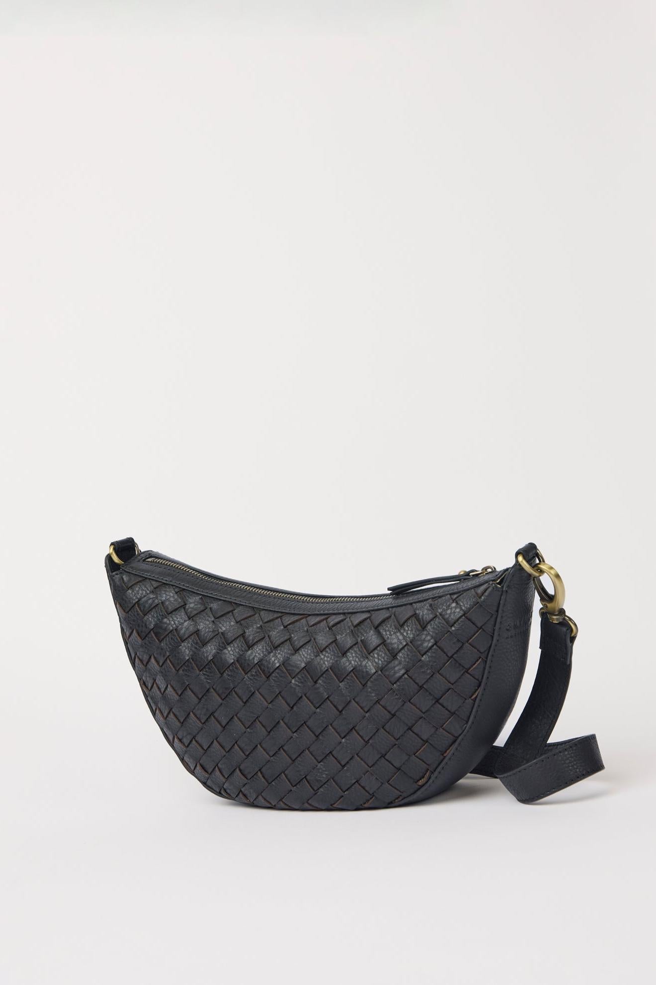 Black woven handbag on a light gray background