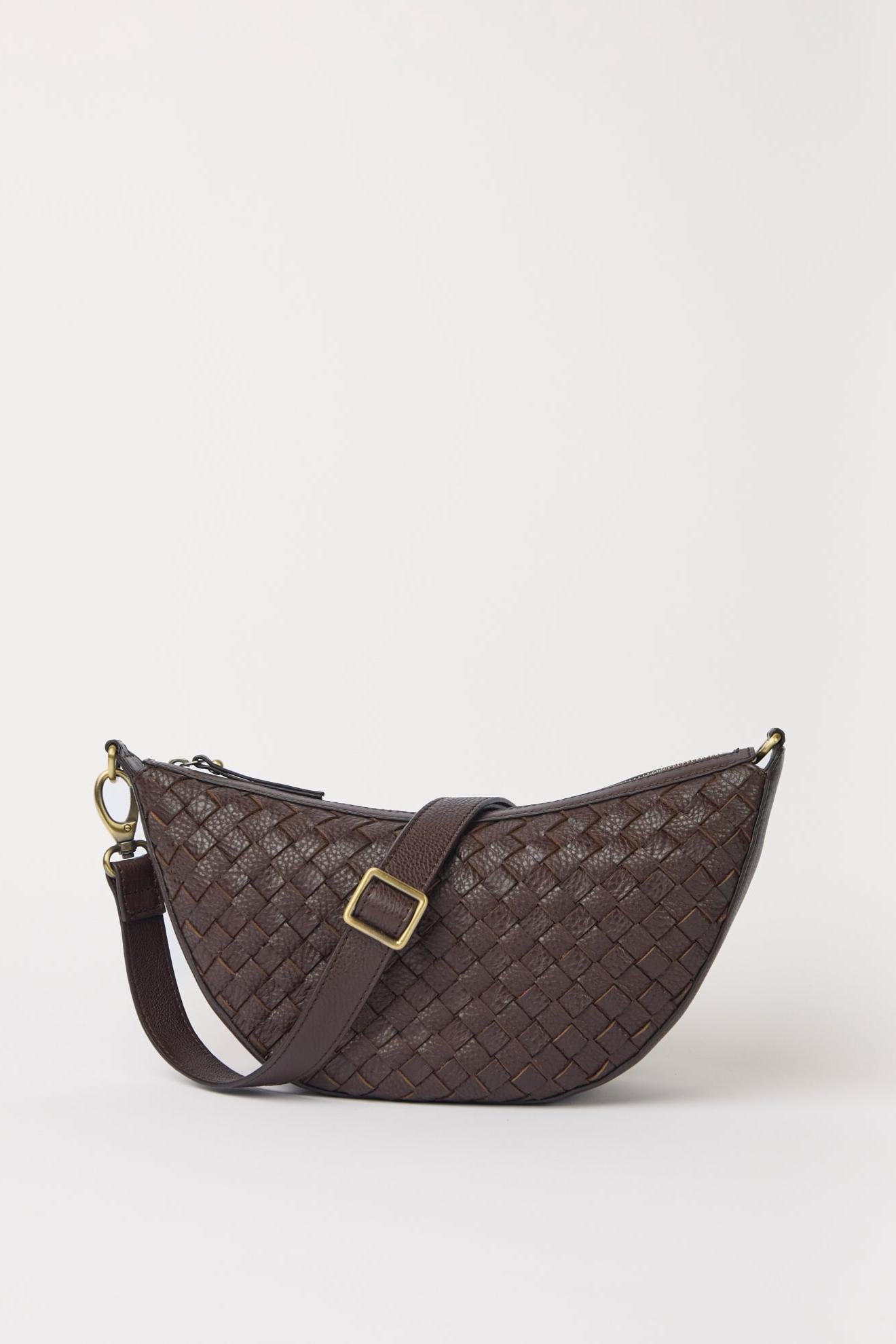 Brown woven handbag with a strap on a white background
