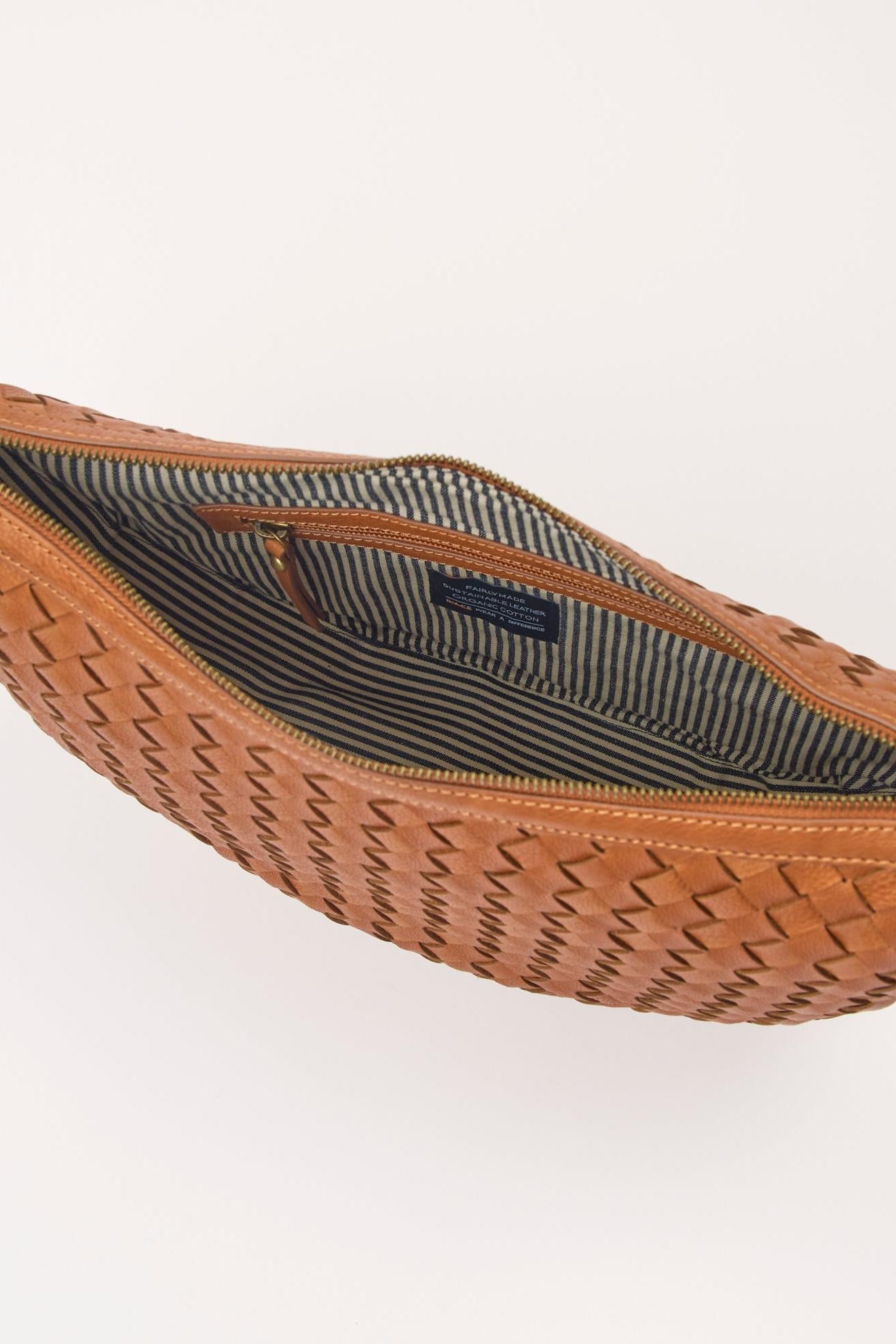 Brown woven bag with a visible brand label on a white background