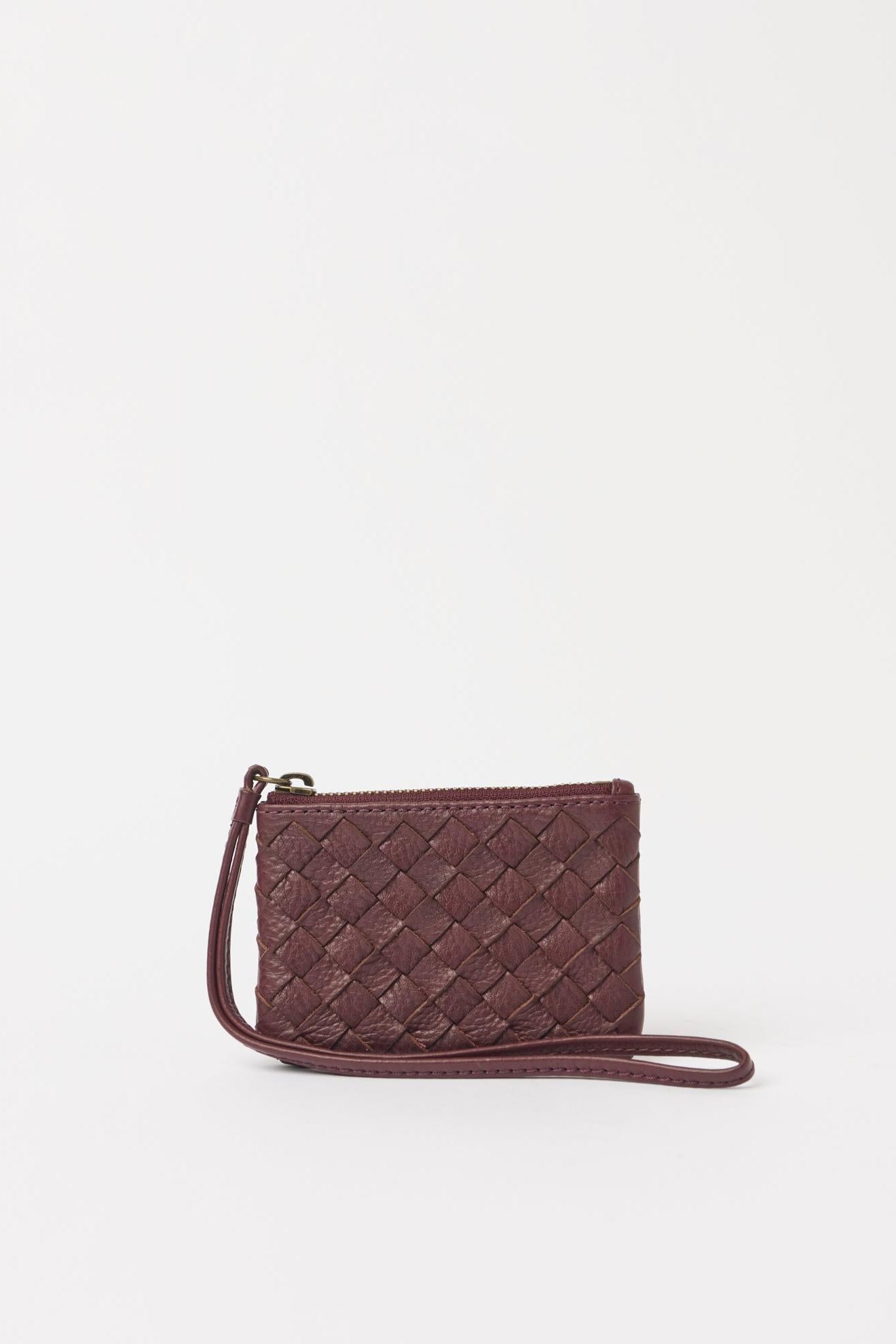 Wine coloured woven handbag on a white background