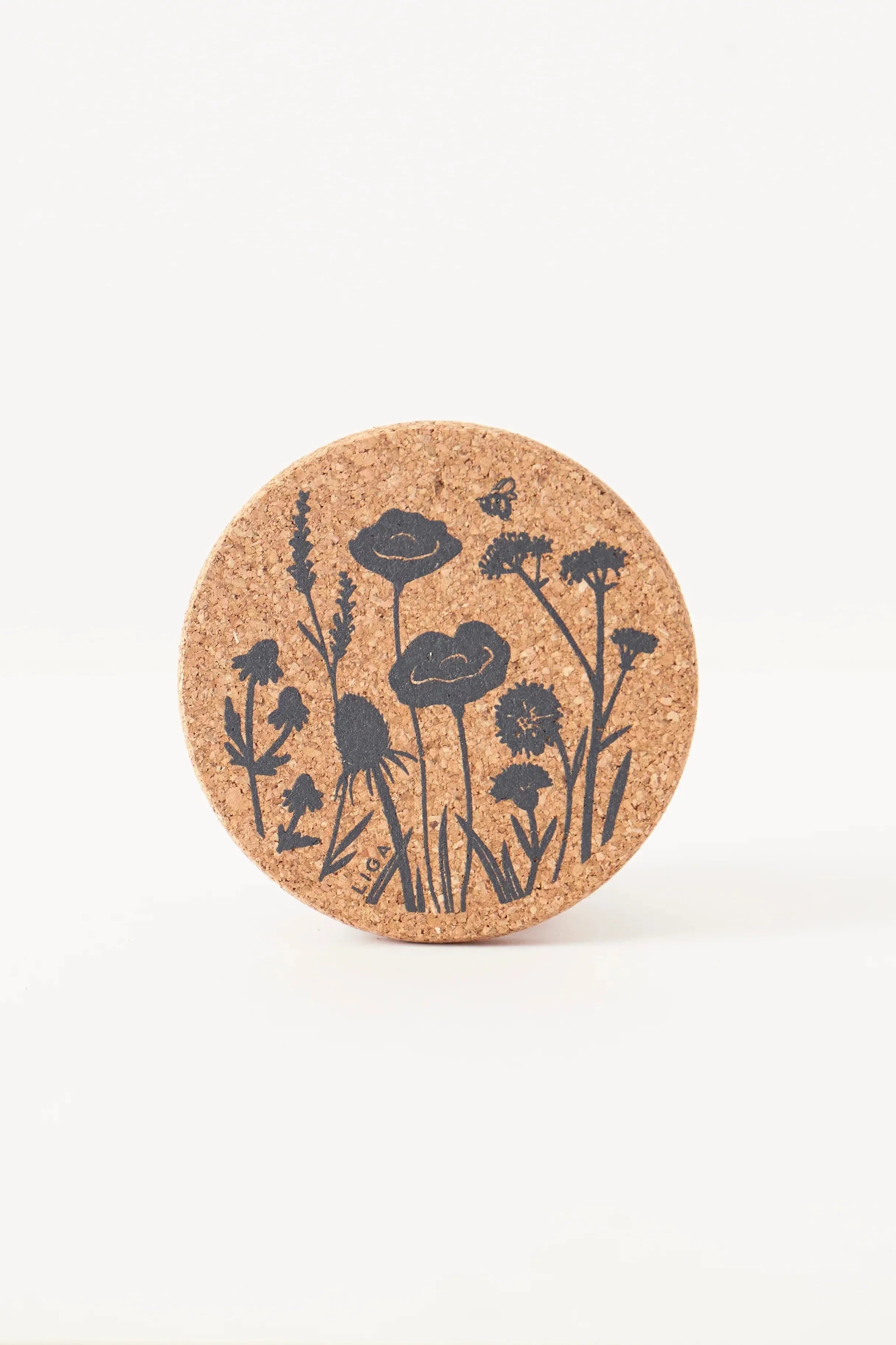 Cork coaster with floral design on a white background