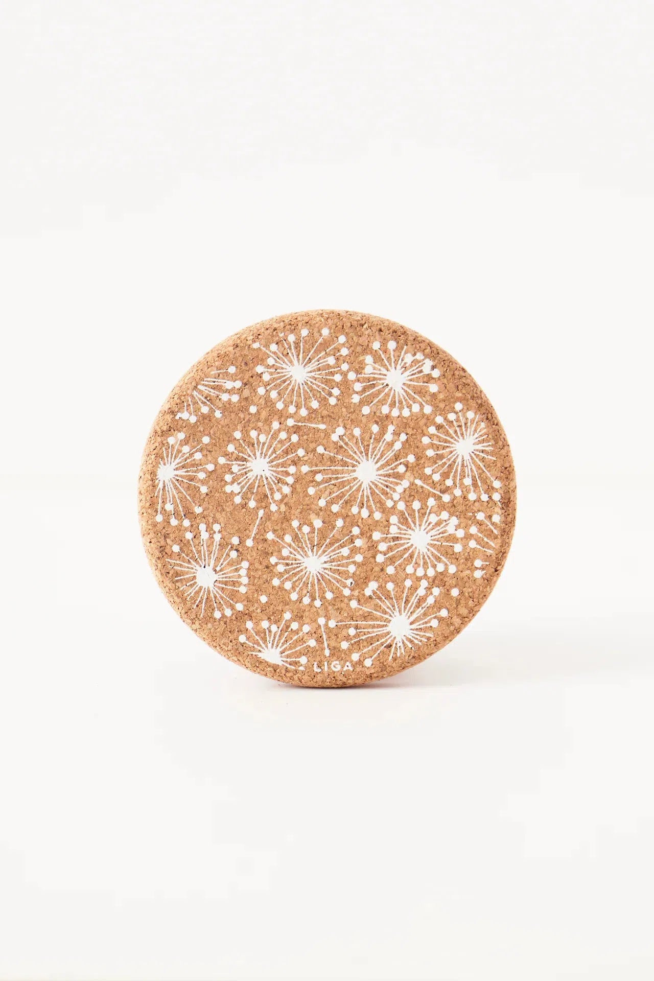 Detailed view of single  Liga Cork Coaster, highlighting the dandelion design and natural cork texture.