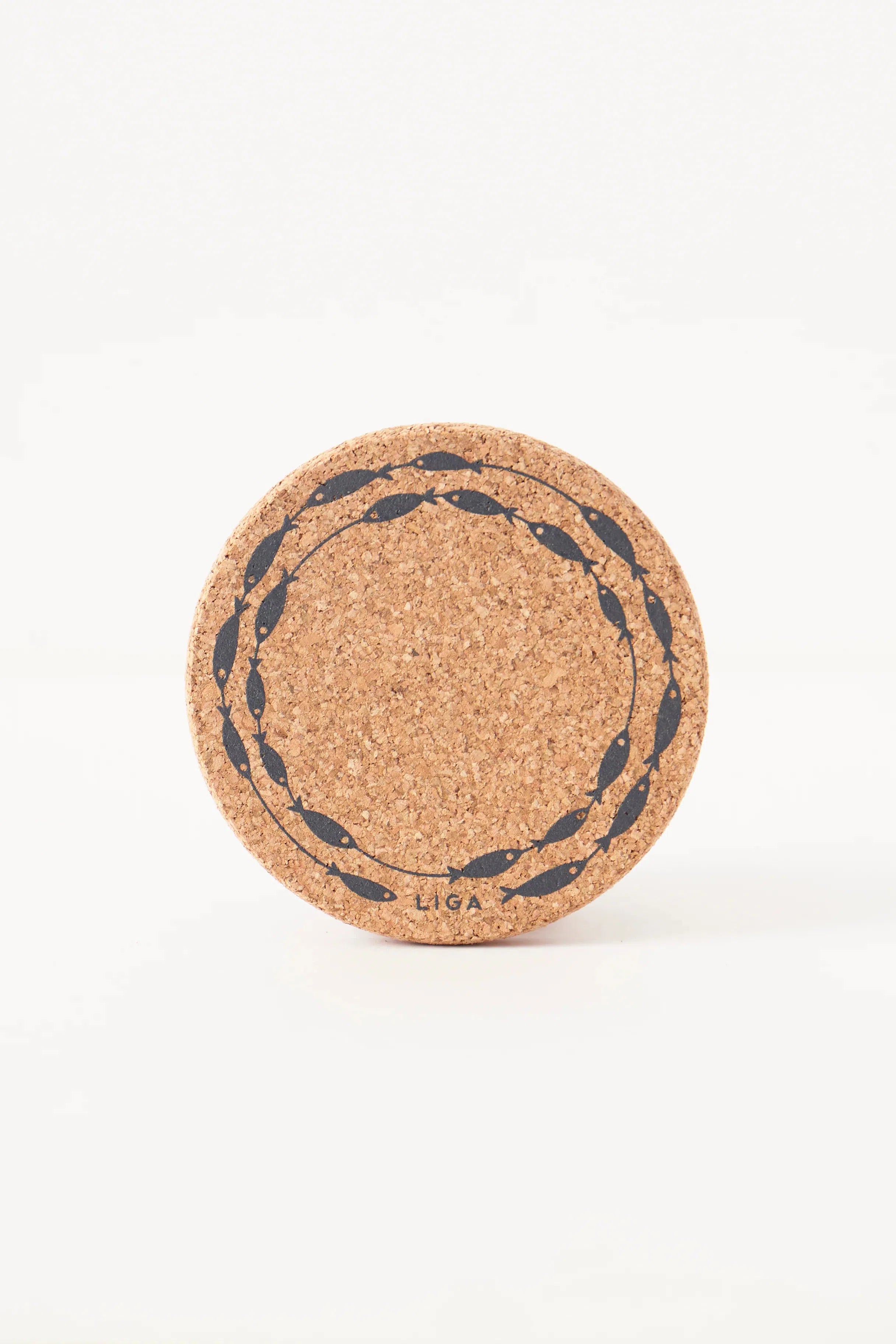 Close-up of Liga Cork Coaster with detailed fish-on-a-line illustration on the textured cork surface.