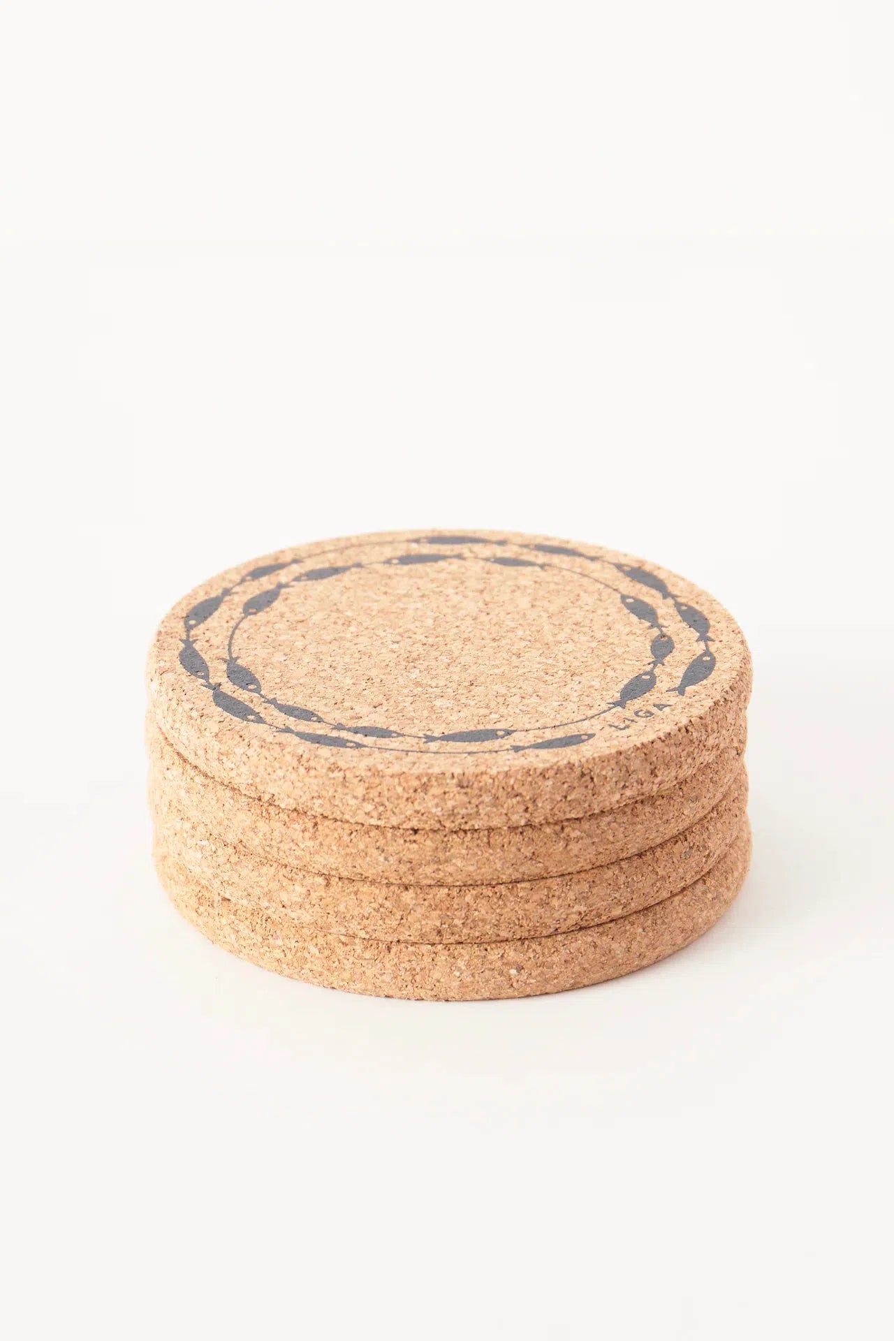 Liga Cork Coaster featuring a playful fish-on-a-line design stacked on top of each other.