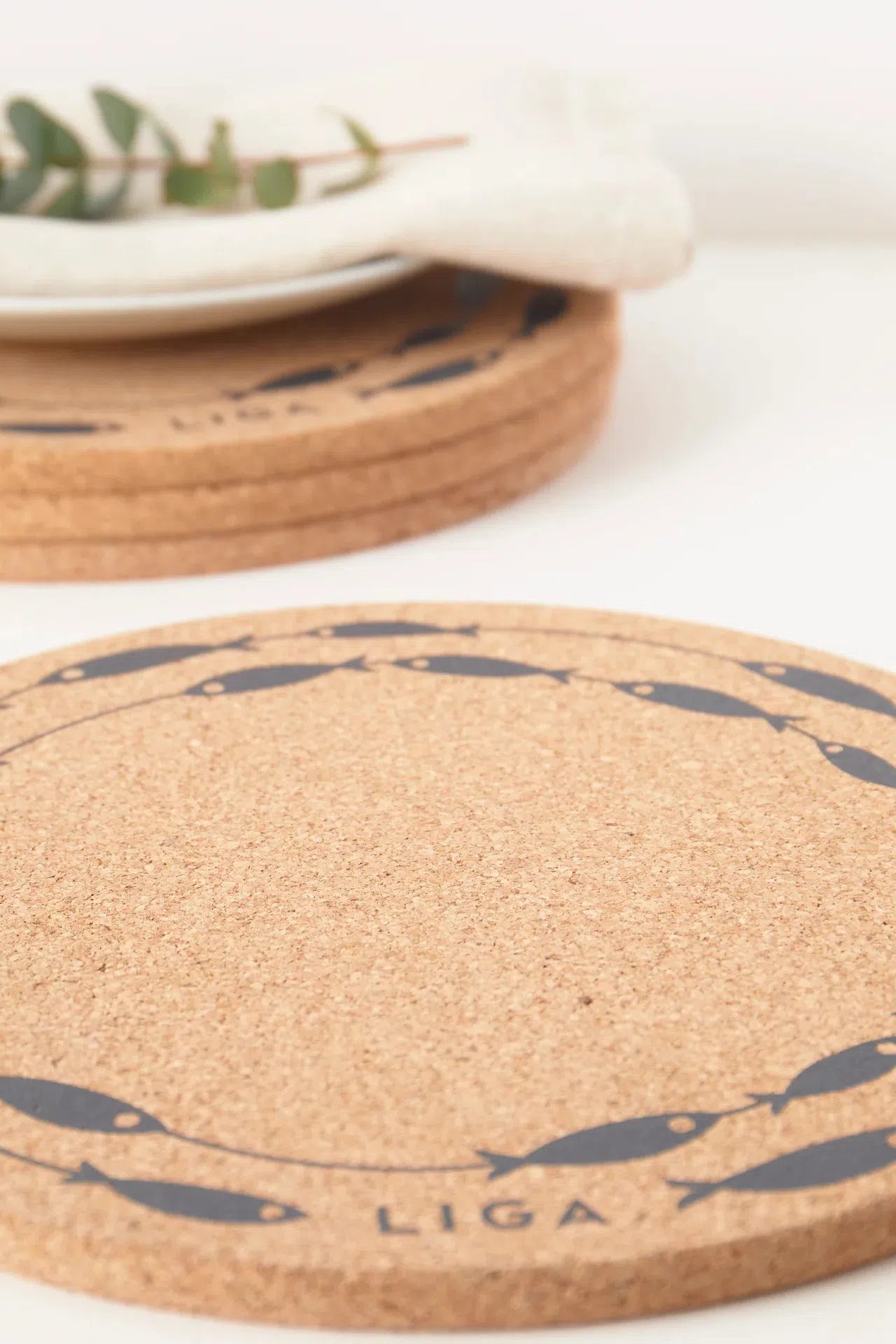 Close up of fish on a line design on cork sustainable placements.