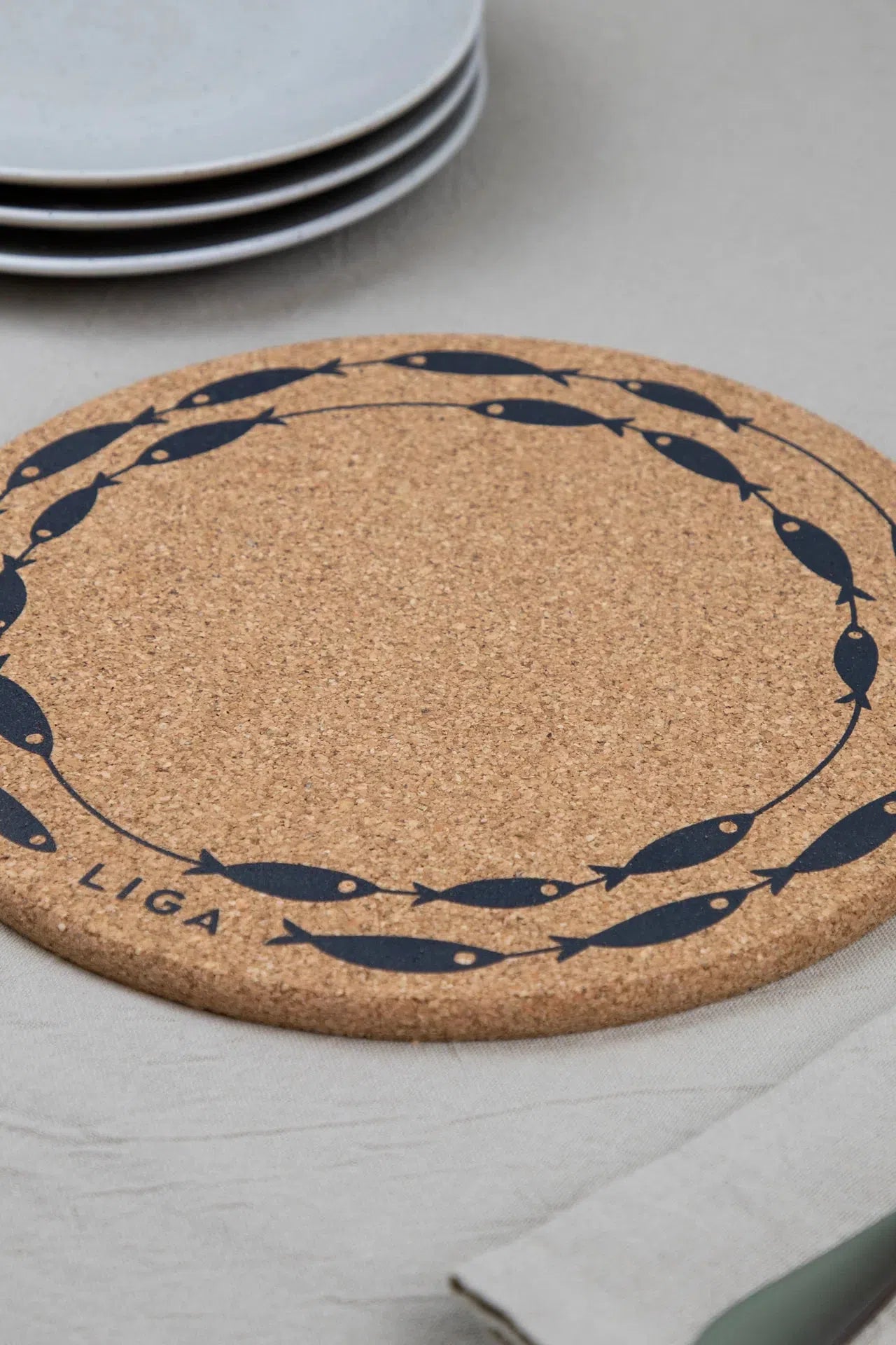Liga Cork Placemat featuring a minimalist fish-on-a-line design, made from sustainable cork.