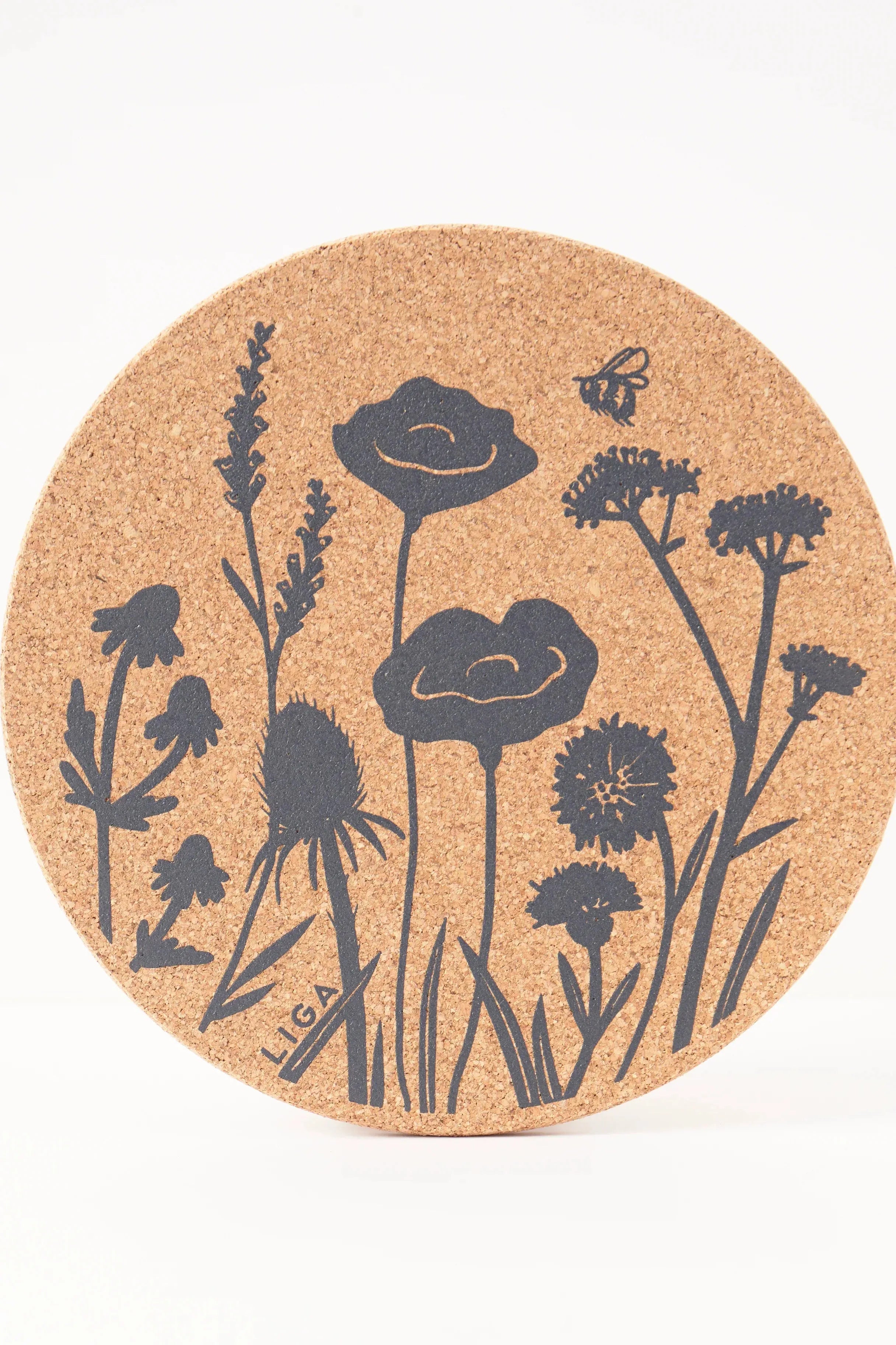 Cork coaster with black floral design on a white background