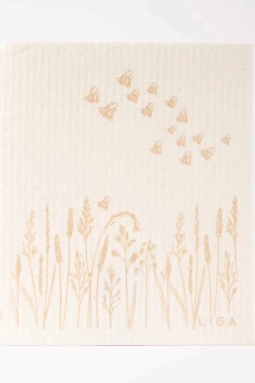 Decorative dishcloth with gold botanical patterns on a beige background