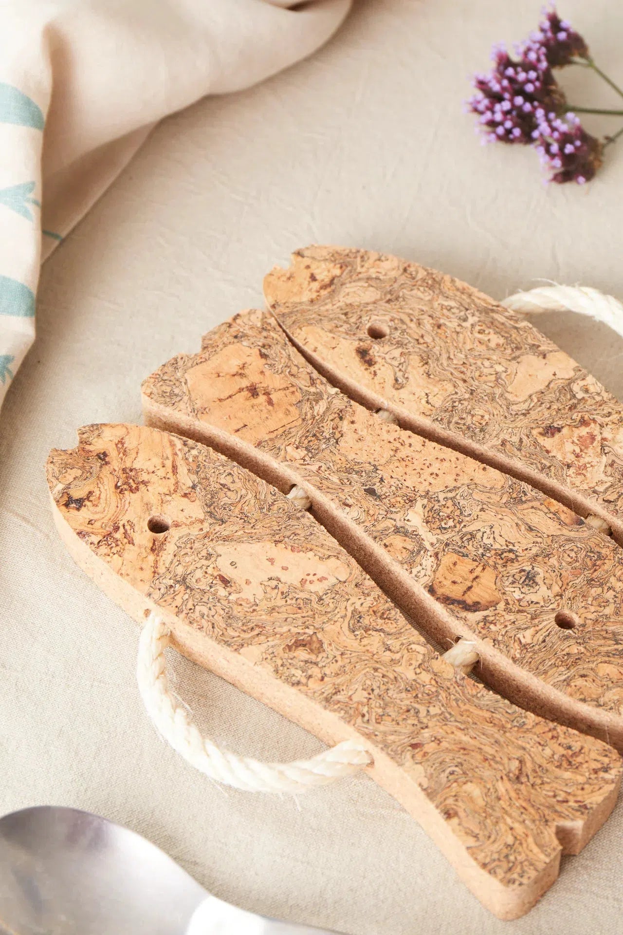 Detailed view of the Liga Natural Cork 3 Fish Trivet, highlighting the unique patterns and textures of the cork material.