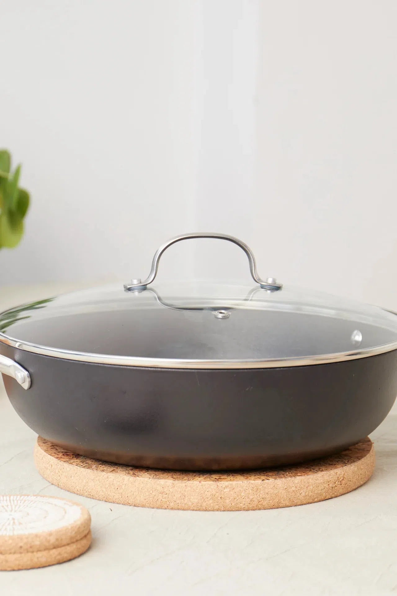 Liga Natural Cork Round Medium Trivet in use under a saucepan on a kitchen countertop.
