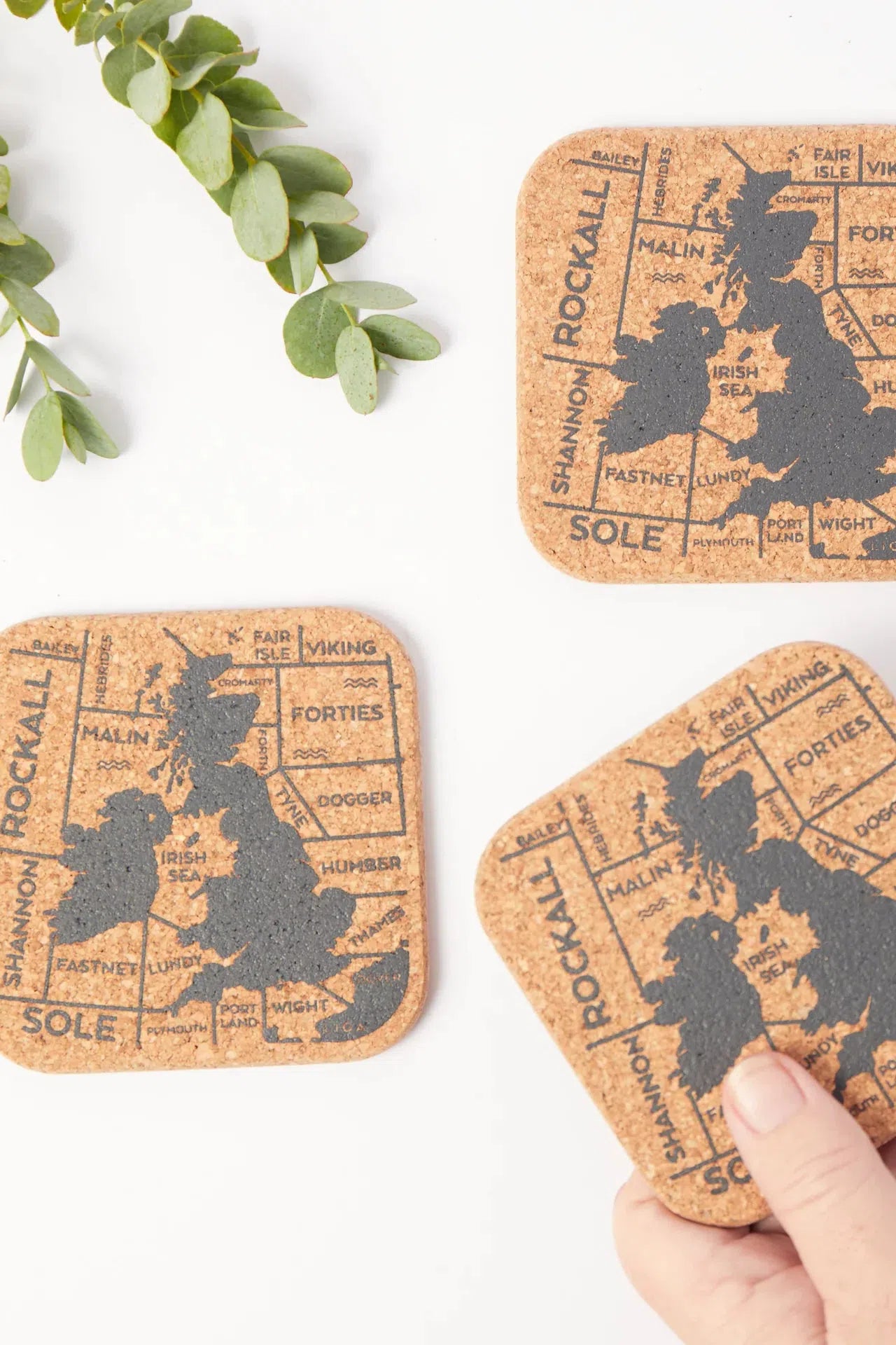 Detailed view of a Liga Organic Cork Coaster, showcasing the 'Shipping Forecast' design.