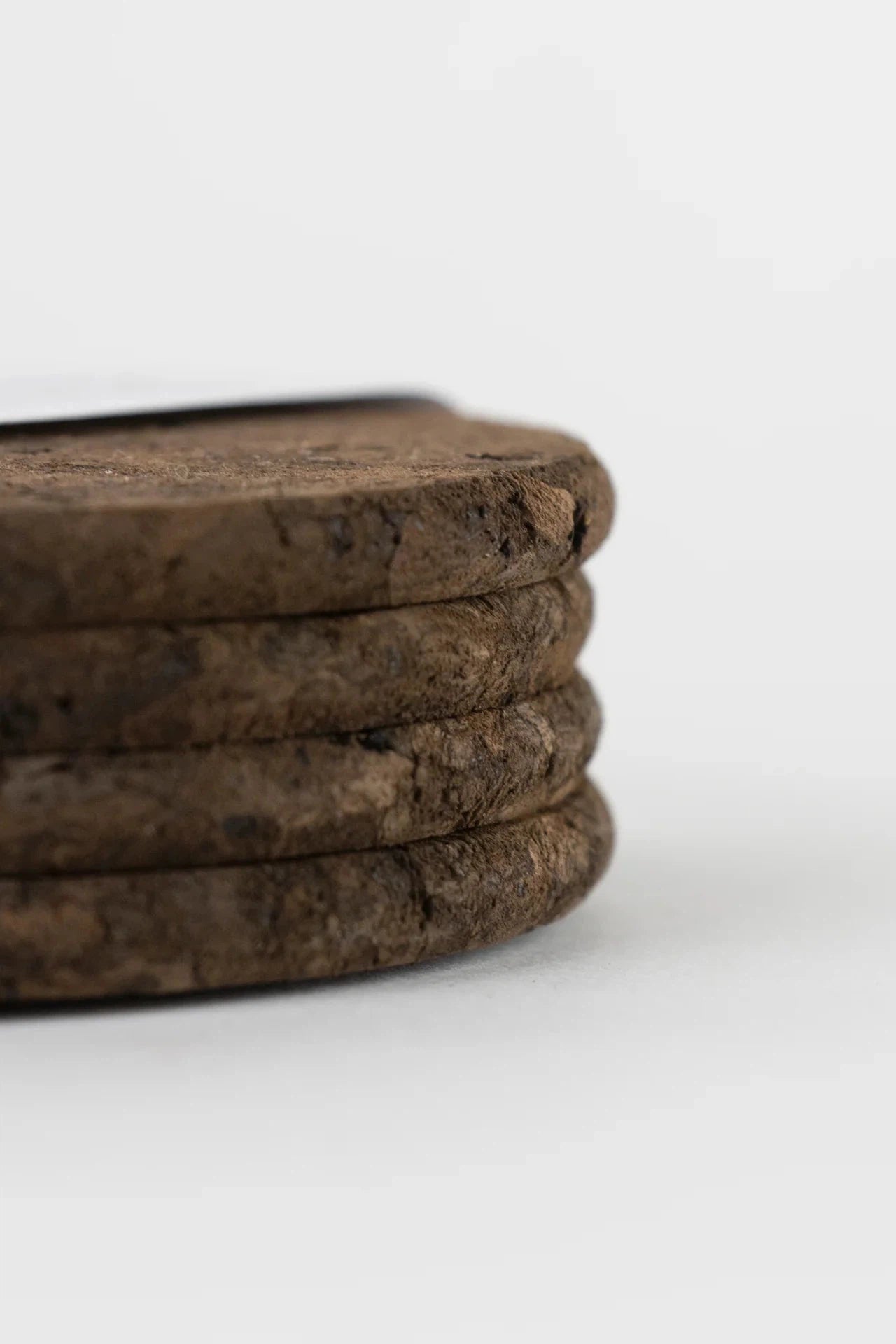 Liga Smoked Cork Round Coasters stacked on top of each other.