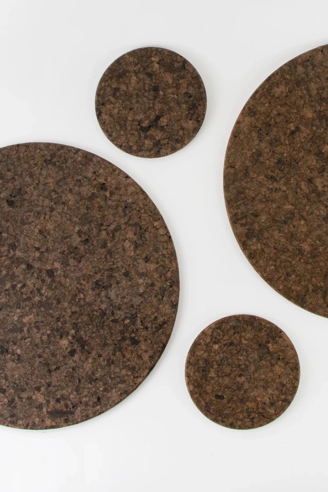 Set of Liga Smoked Cork Round Placemats with matching cork coasters.