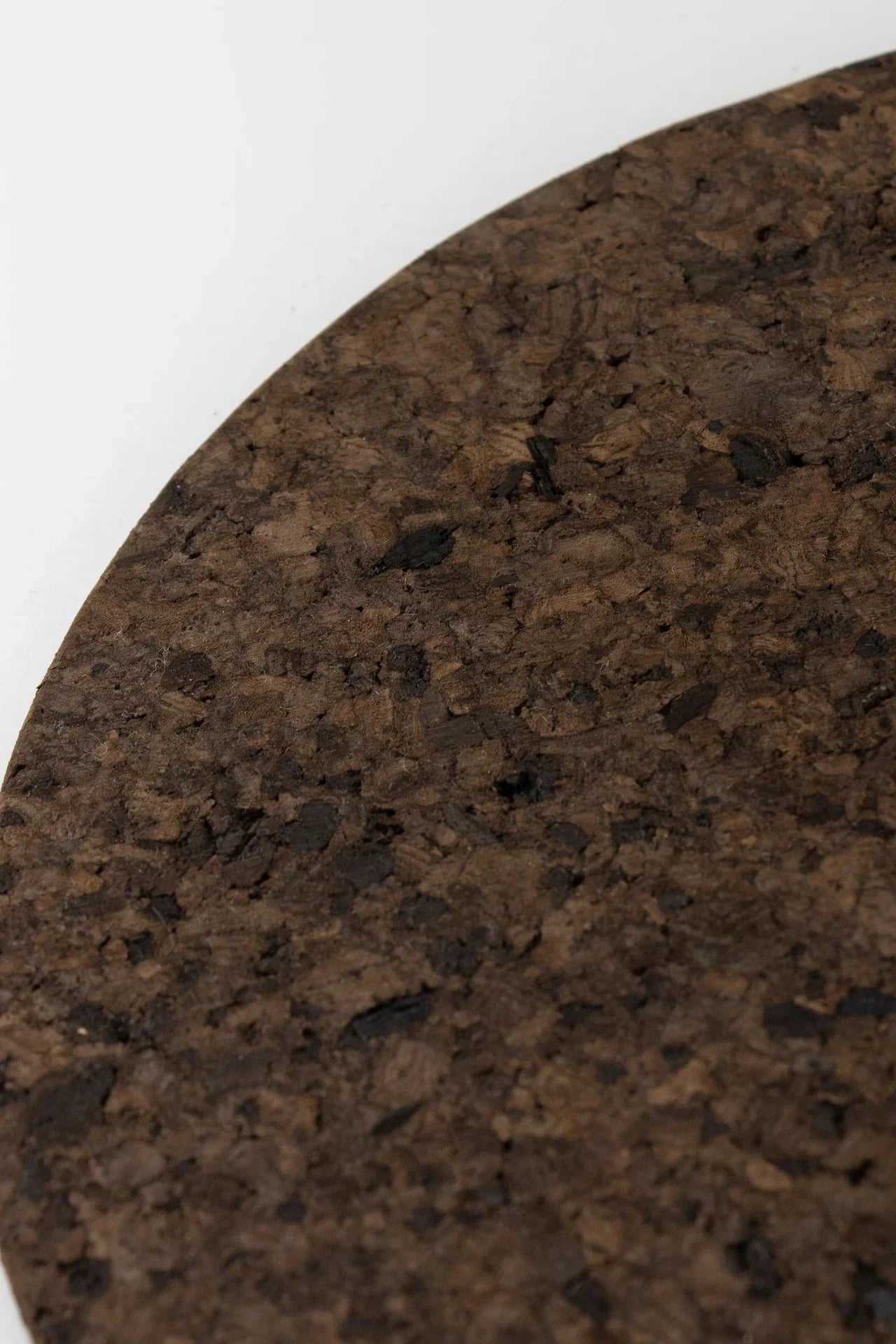 Close up of the texture of Liga Smoked Cork Round Placemat.