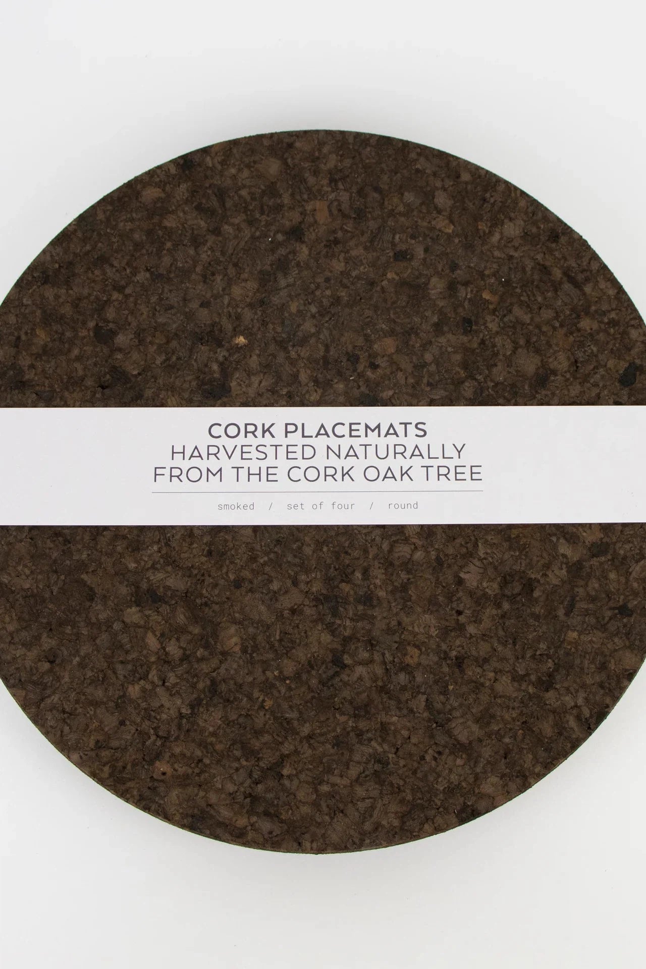 Liga Smoked Cork Round Placemat with white packaging band.