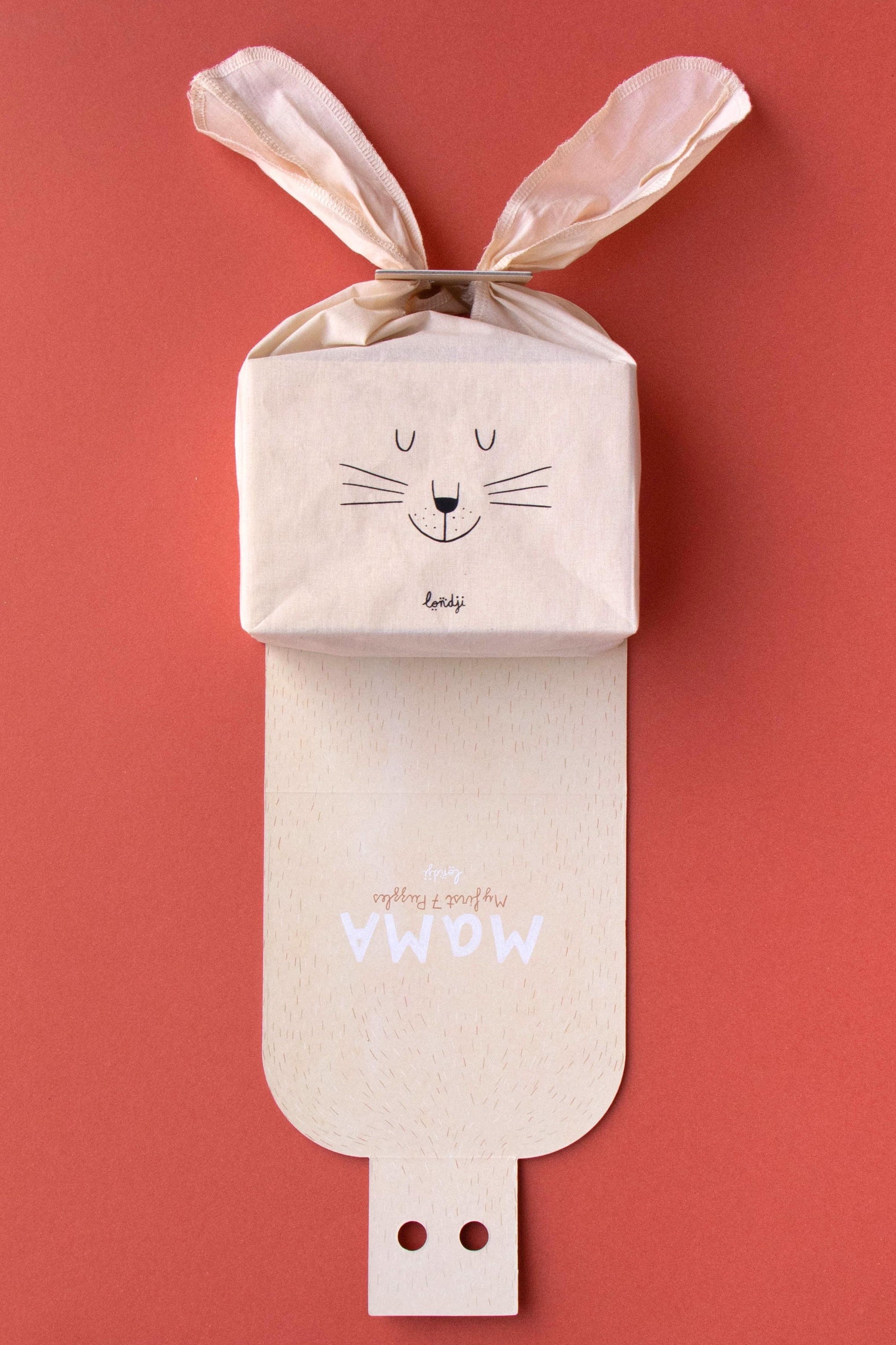 Baby bag with rabbit ears on a red background