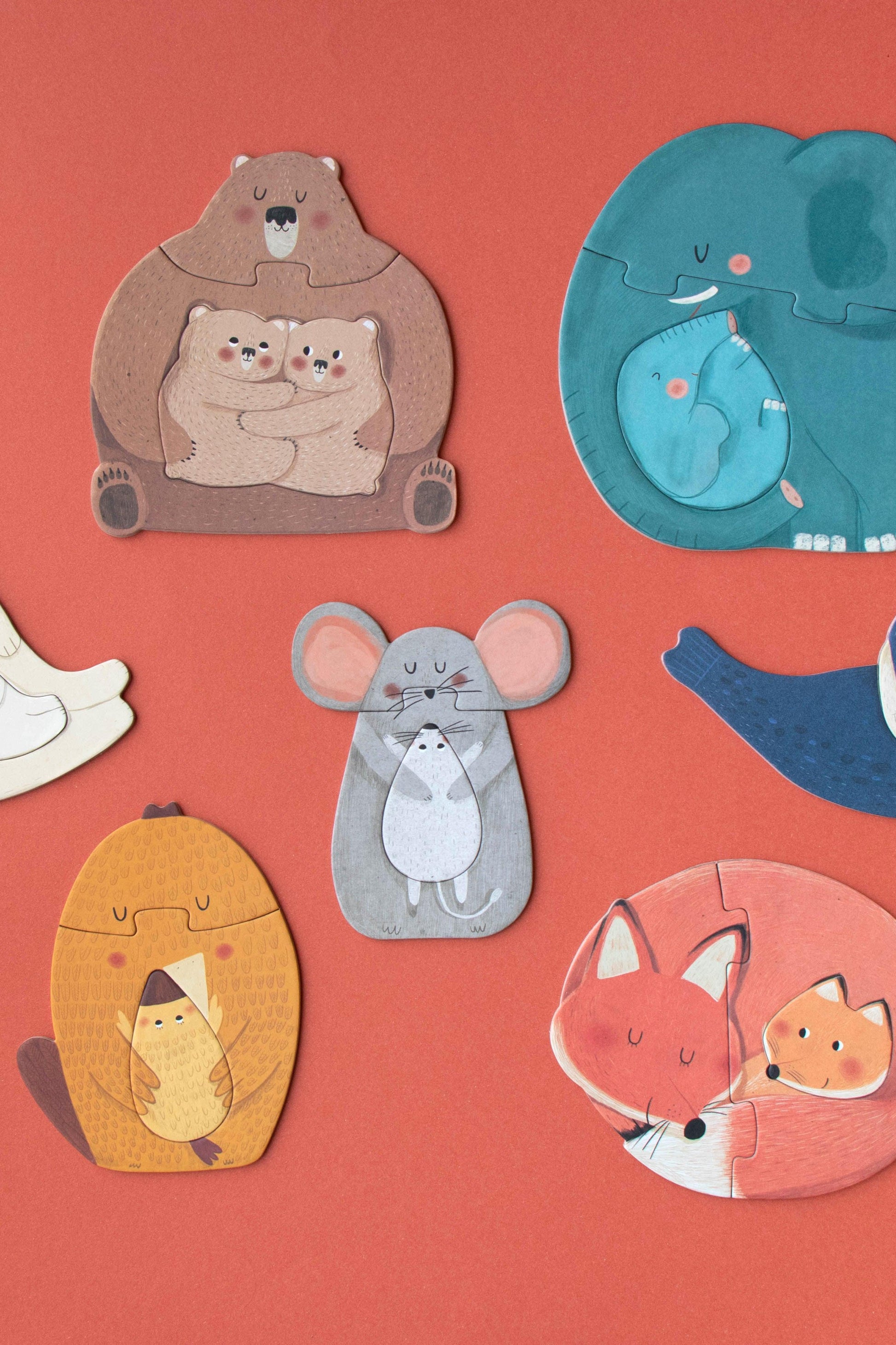 Illustrations of cute animal family figures on a red background
