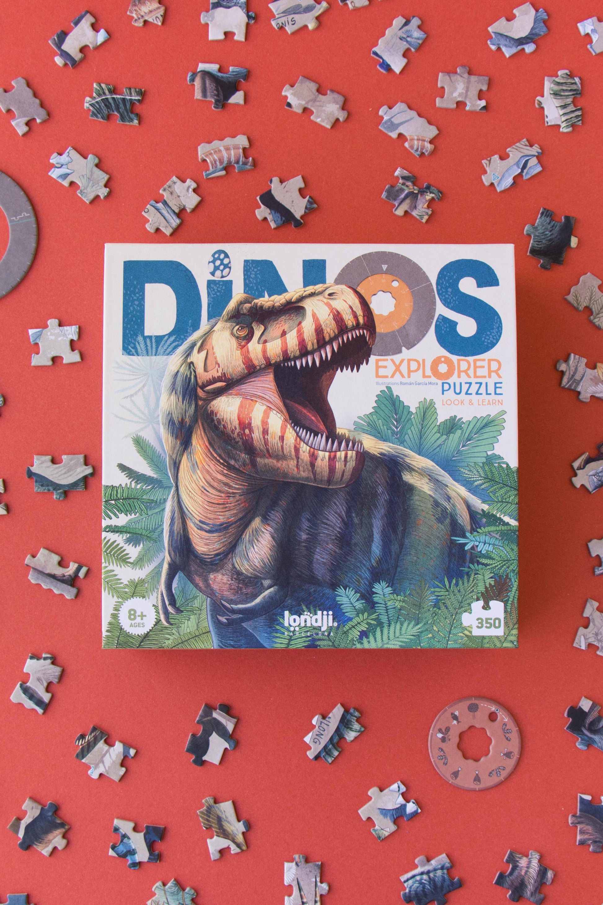 Dinosaur puzzle with pieces scattered on a red background