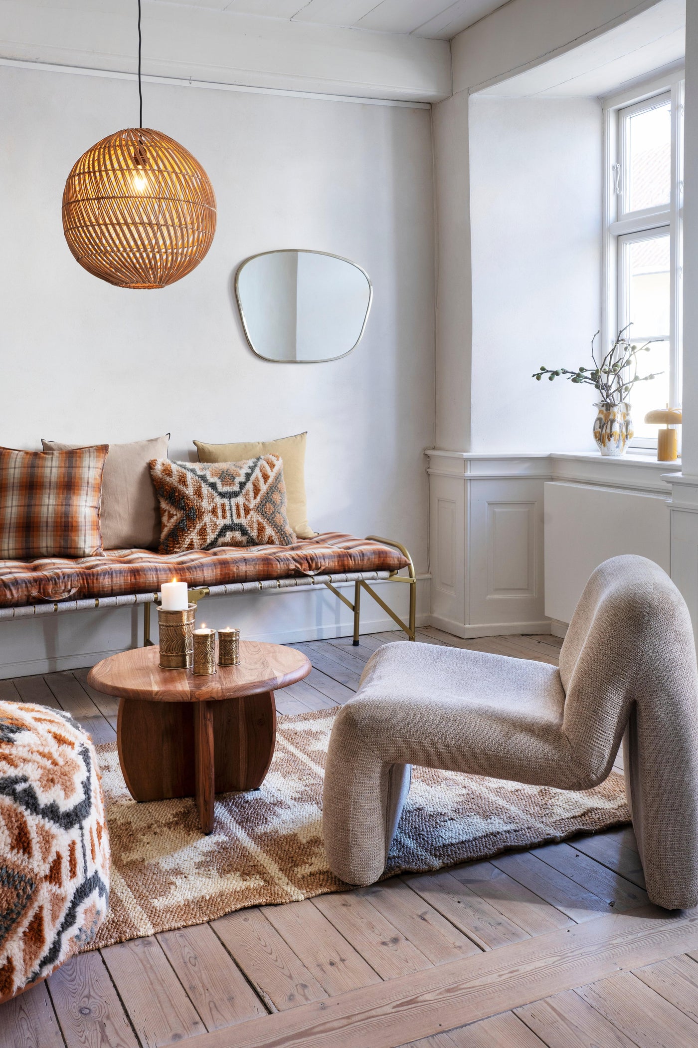 Modern living room with a plaid sofa, wooden coffee table, and unique chair.