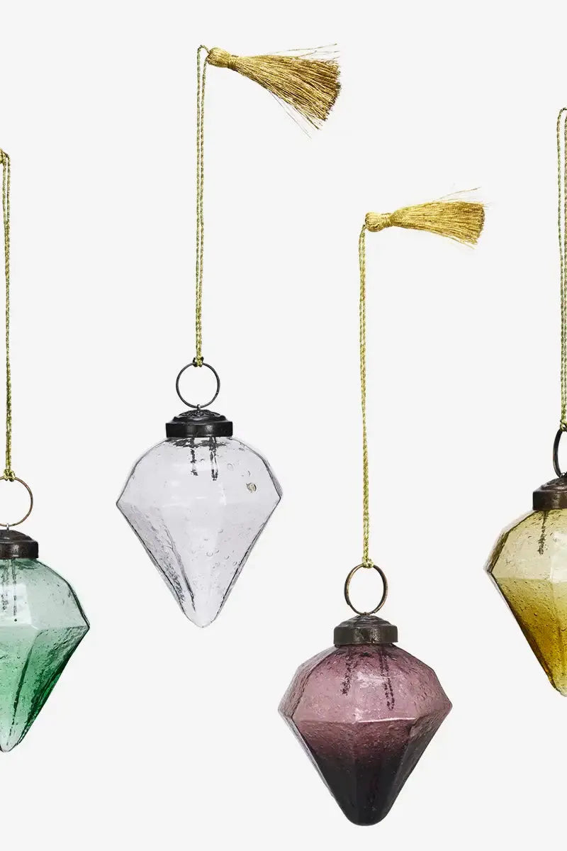Decorative glass ornaments with tassels on a white background