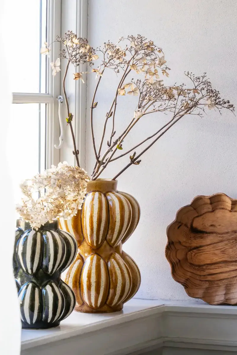 Decorative vases with striped patterns on a windowsill.