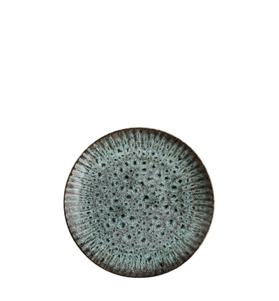 Round ceramic plate with textured surface on a white background